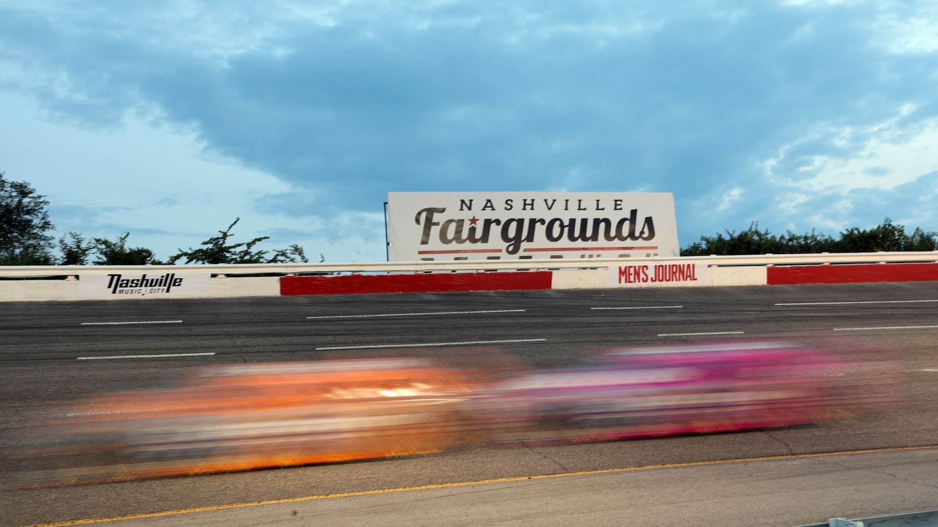 Cars race around the Nashville fairgrounds racetrack