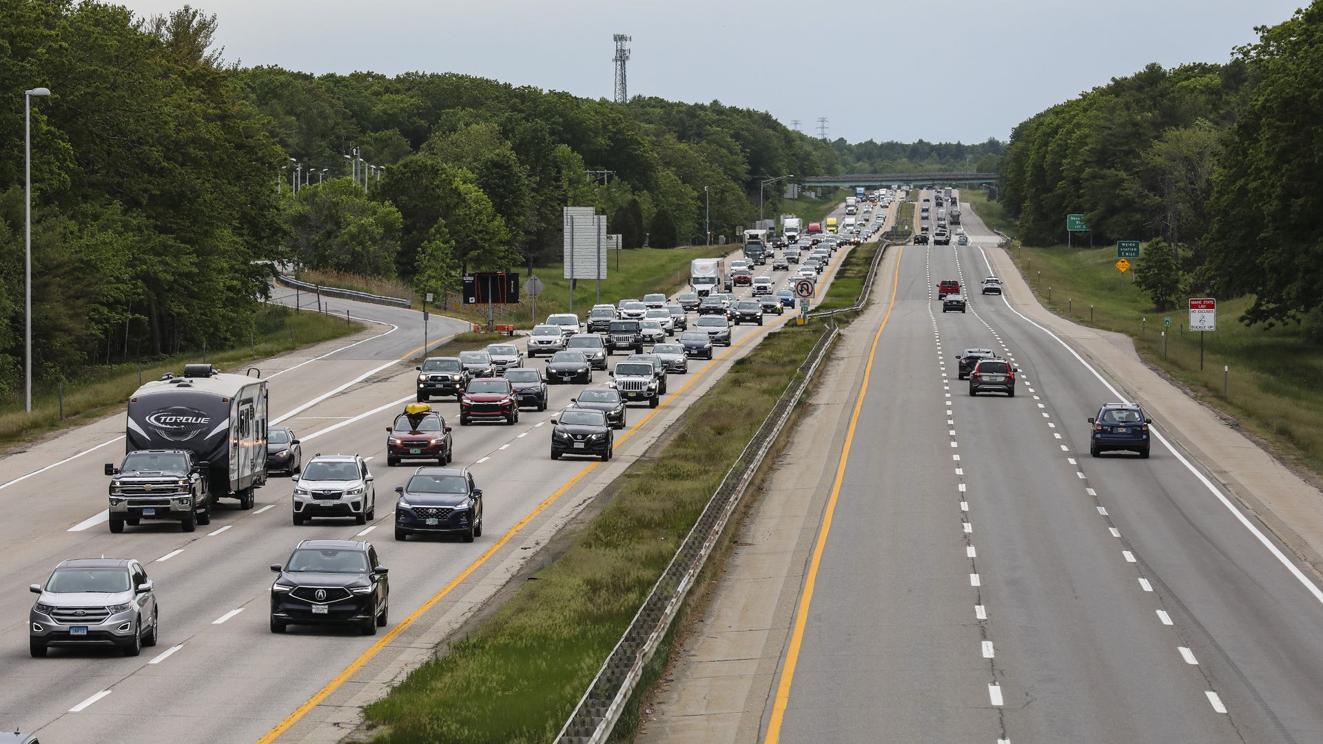 The southbound lane of the Maine Turnpike remains relatively empty while the northbound buzzes with traffic as people drive up to Maine for Memorial Day weekend in York, ME on May 28, 2021.