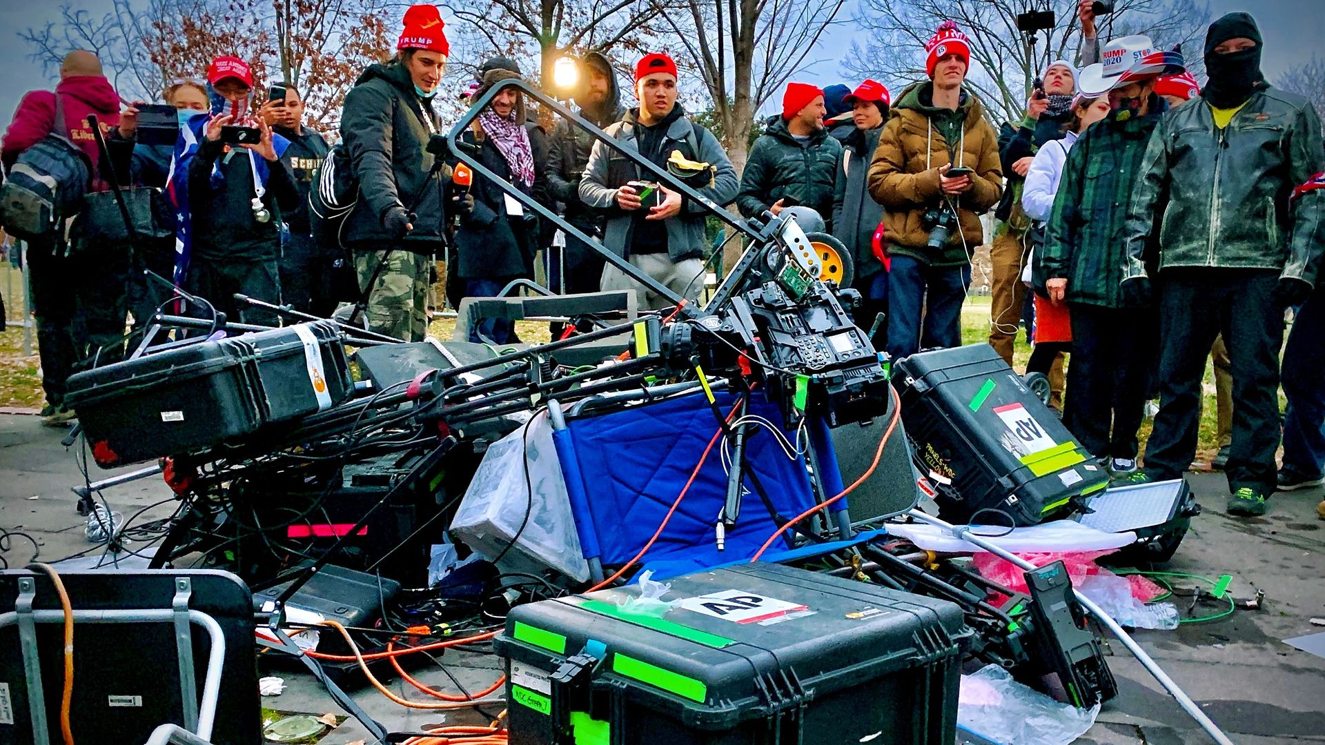 Supporters of US President Donald Trump stand next to media equipment they destroyed during a protest on January 6, 2021 outside the Capitol in Washington, DC.