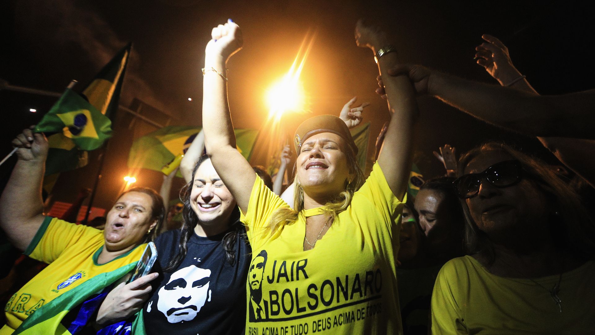 Supporters of far-right presidential candidate Jair Bolsonaro, celebrate in front of his house in Rio de Janeiro, Brazil, after he won Brazil's presidential election, on October 28, 2018