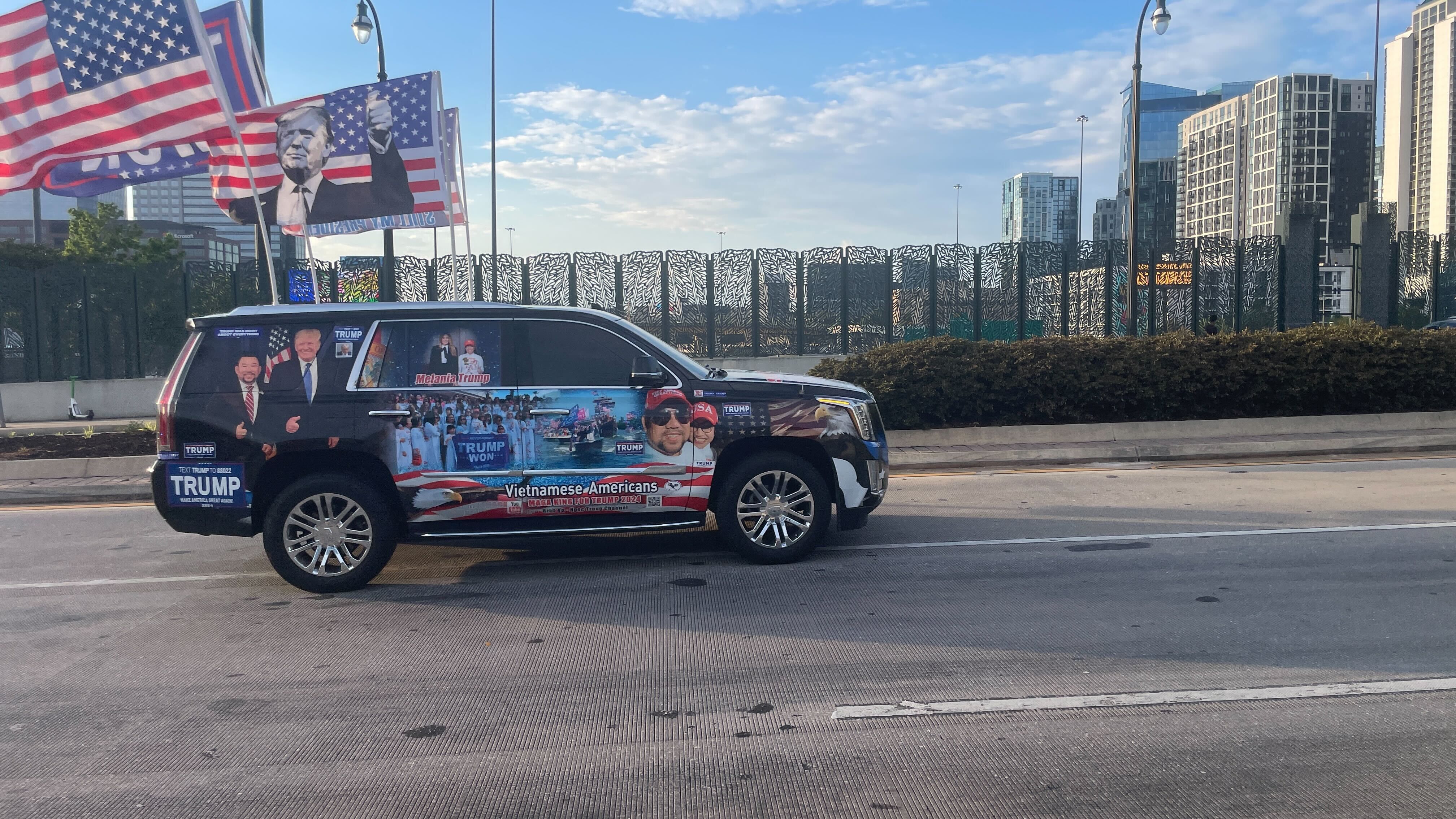 A van detailed with Trump photos. It also has large American flags and Trump campaign flags.