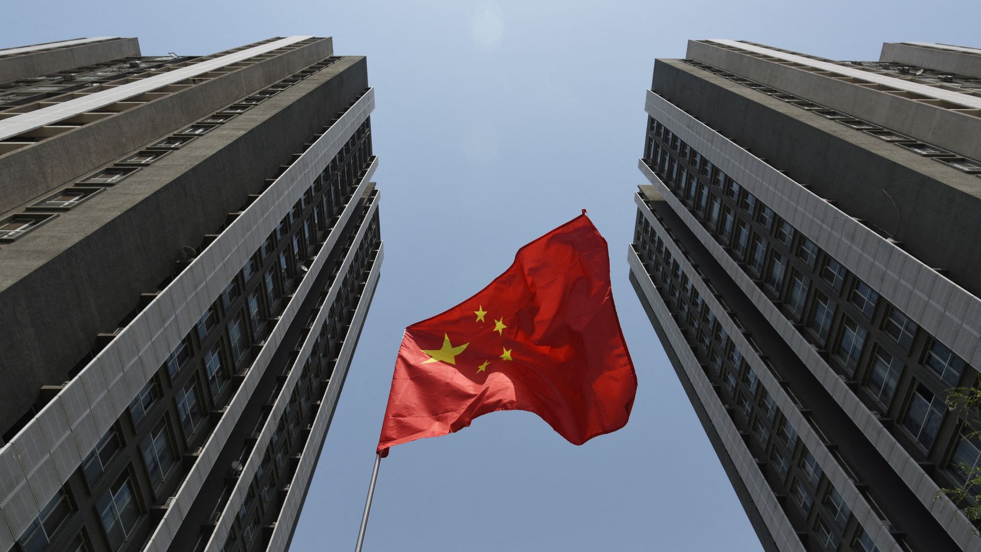 An image of a Chinese flag flying outside a residential compound in Beijing.