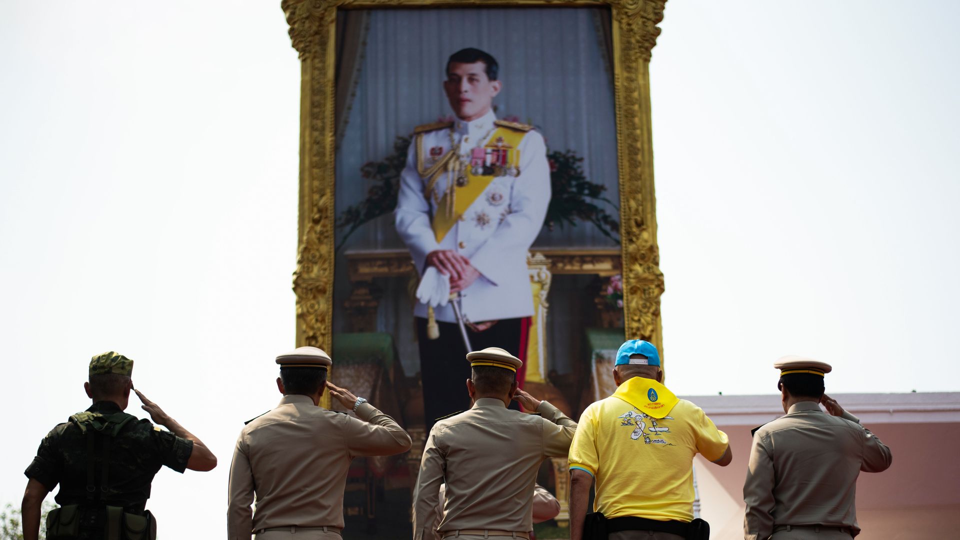 Thai Prime Minister, Royal Thai Army Commander in Chief and others salute a portrait of King Maha Vajiralongkorn
