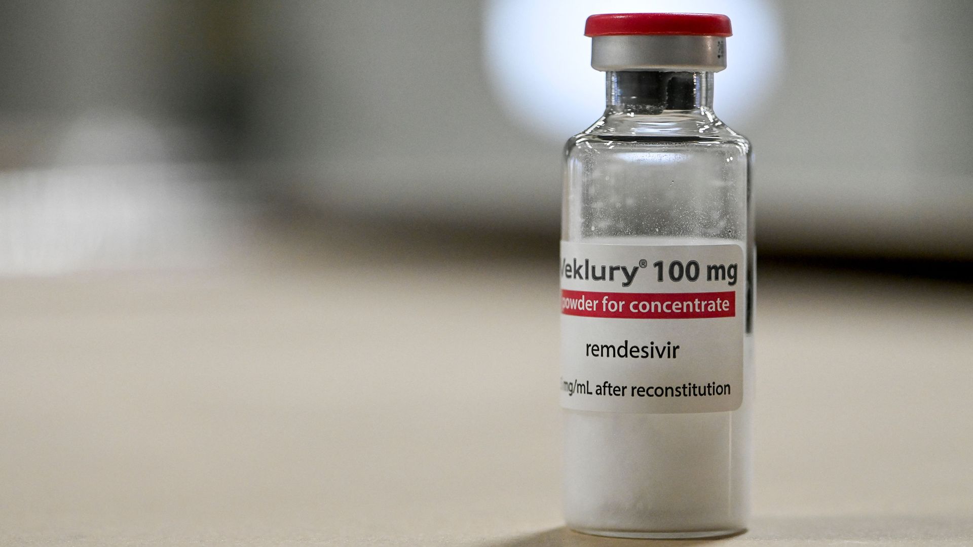 A transparent vial of Veklury (remdesivir) with a red and white label.