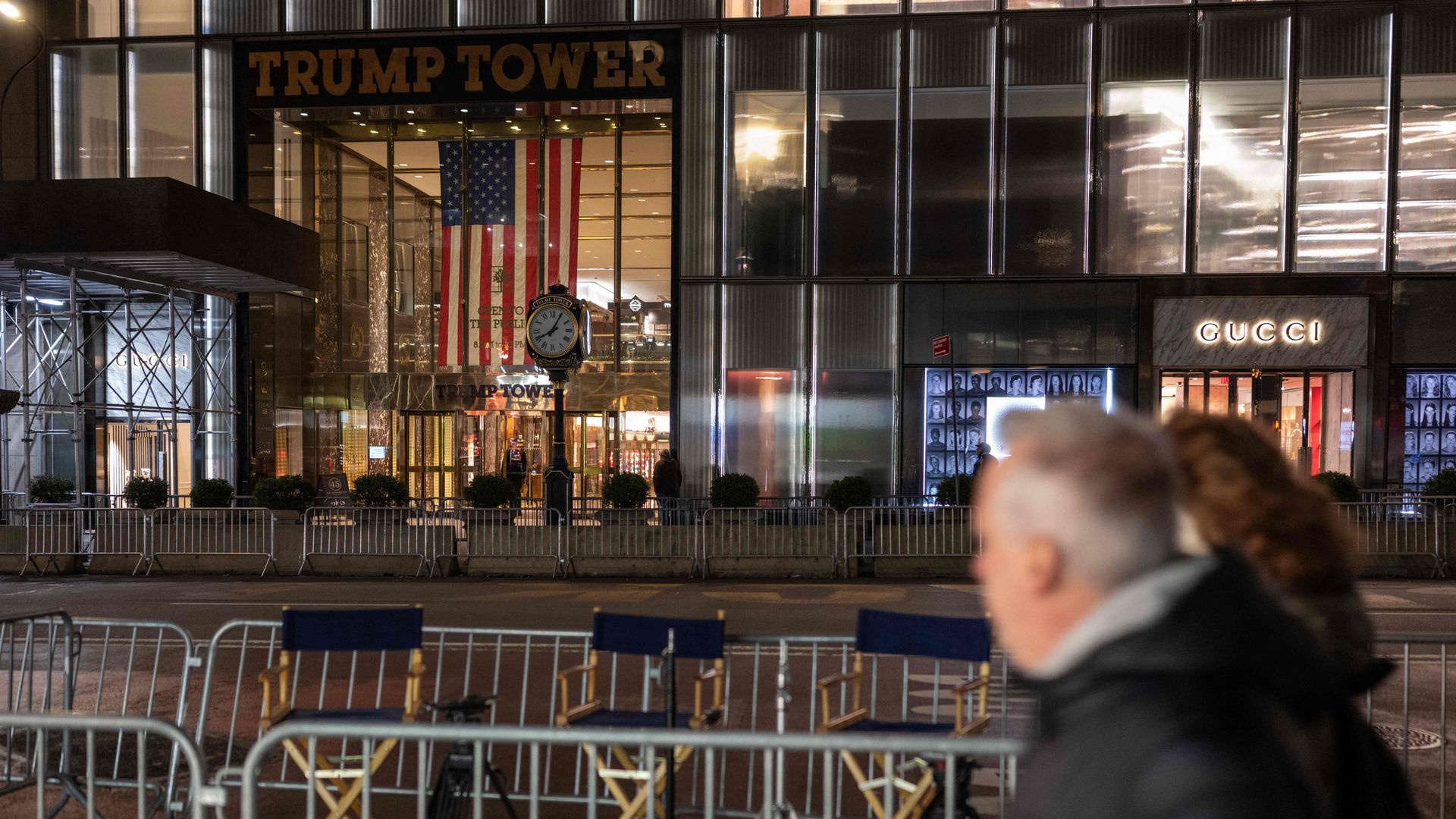 People walk past media pens setup across the street from Trump Tower in New York, New York on April 2.