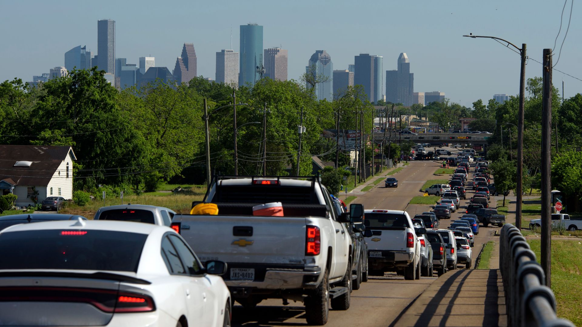 Photo of traffic, with a view of the Houston skyline. 