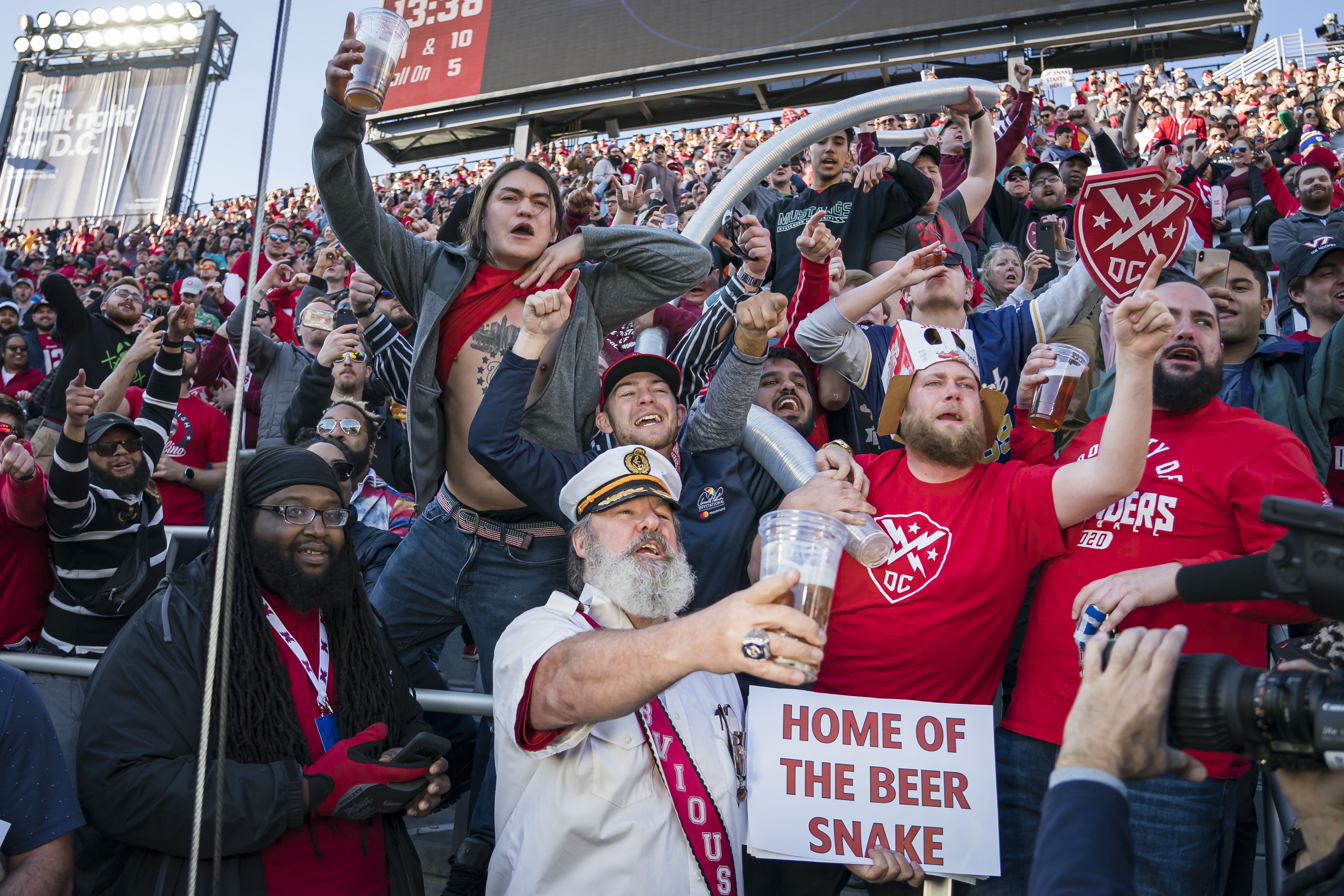 Fans cheer and hold up the Beer Snake