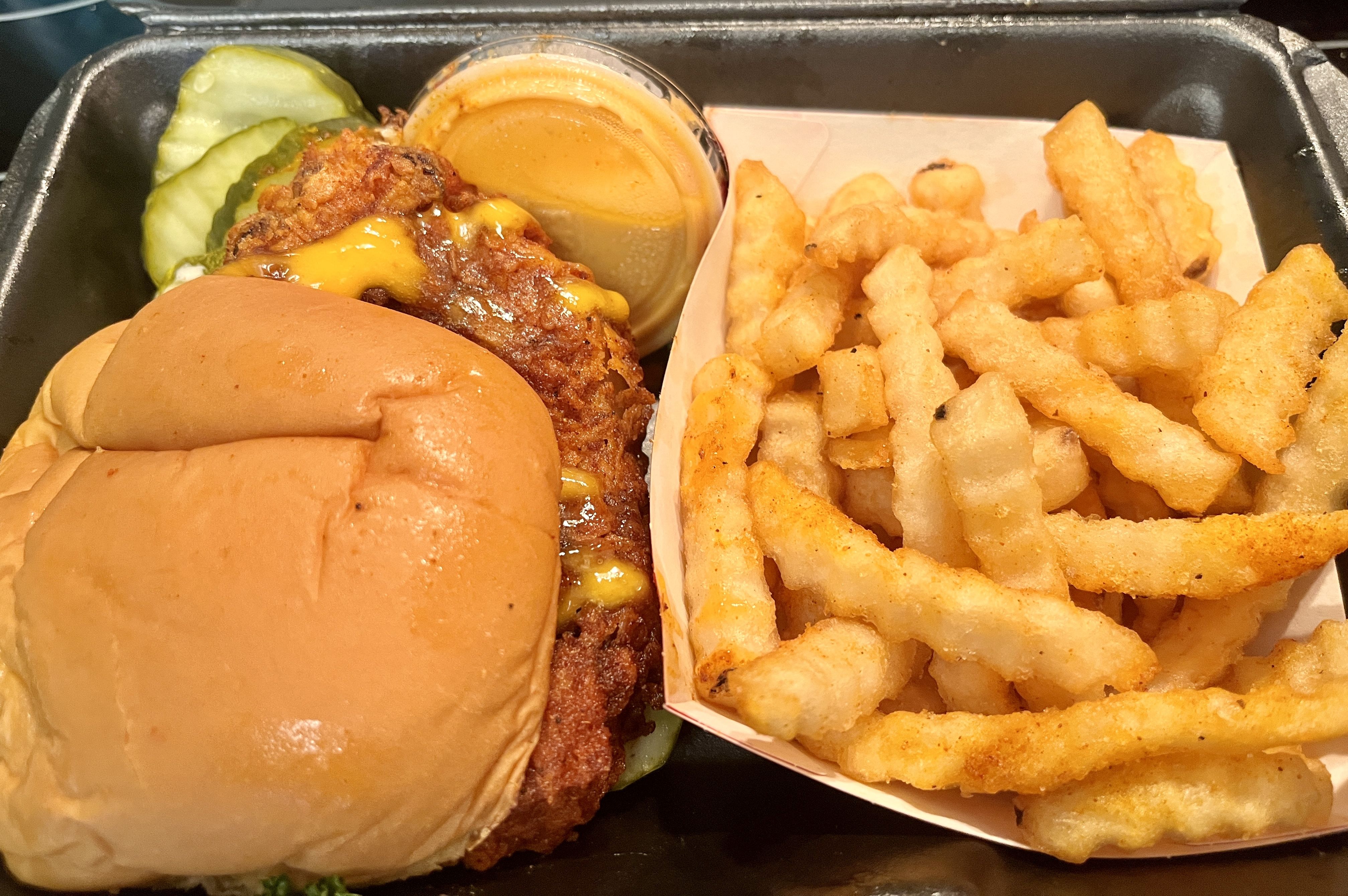 A fried sandwich with french fries. 