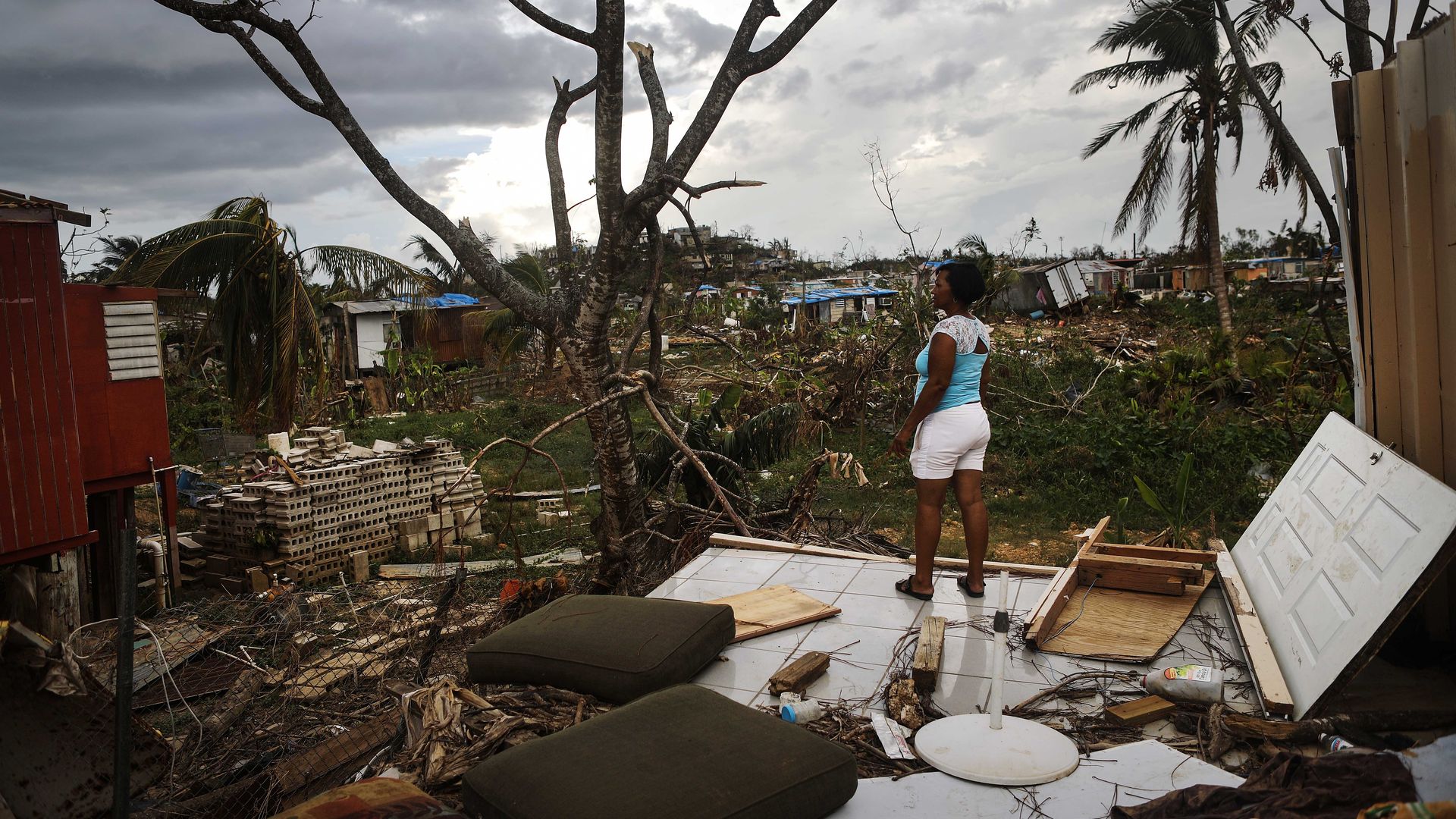 A resident stands on her property after Hurricane Maria swept through Puerto Rico.