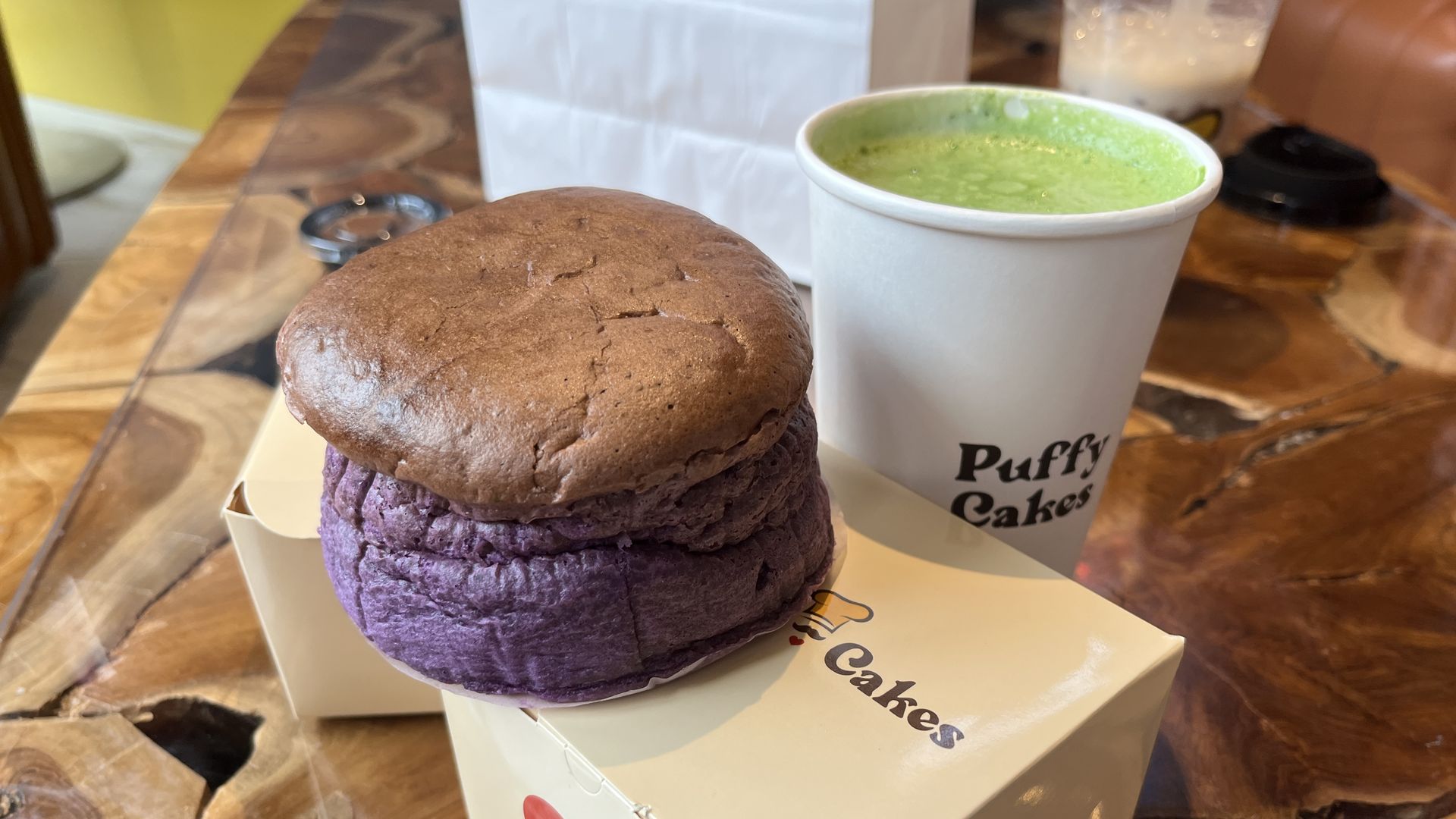 A purple cheesecake with green drink 