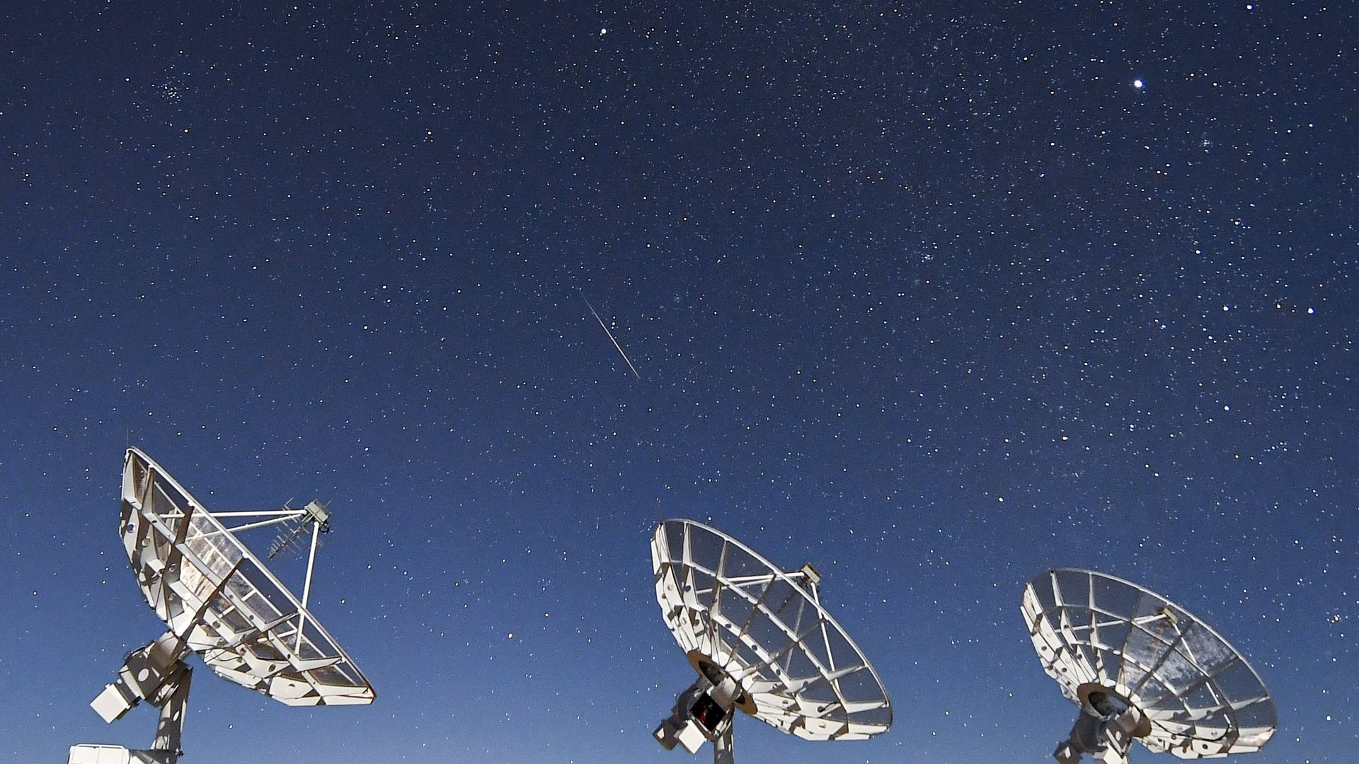 A Geminids meteor seen over radio telescopes in the Sichuan Province of China in December 2021.