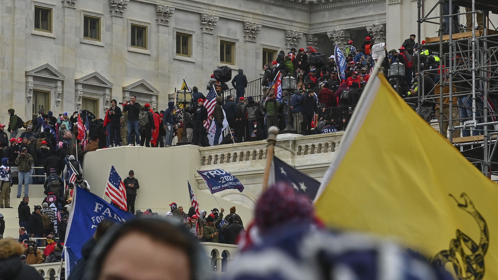 Picture of the Capitol stairs with protesters invading