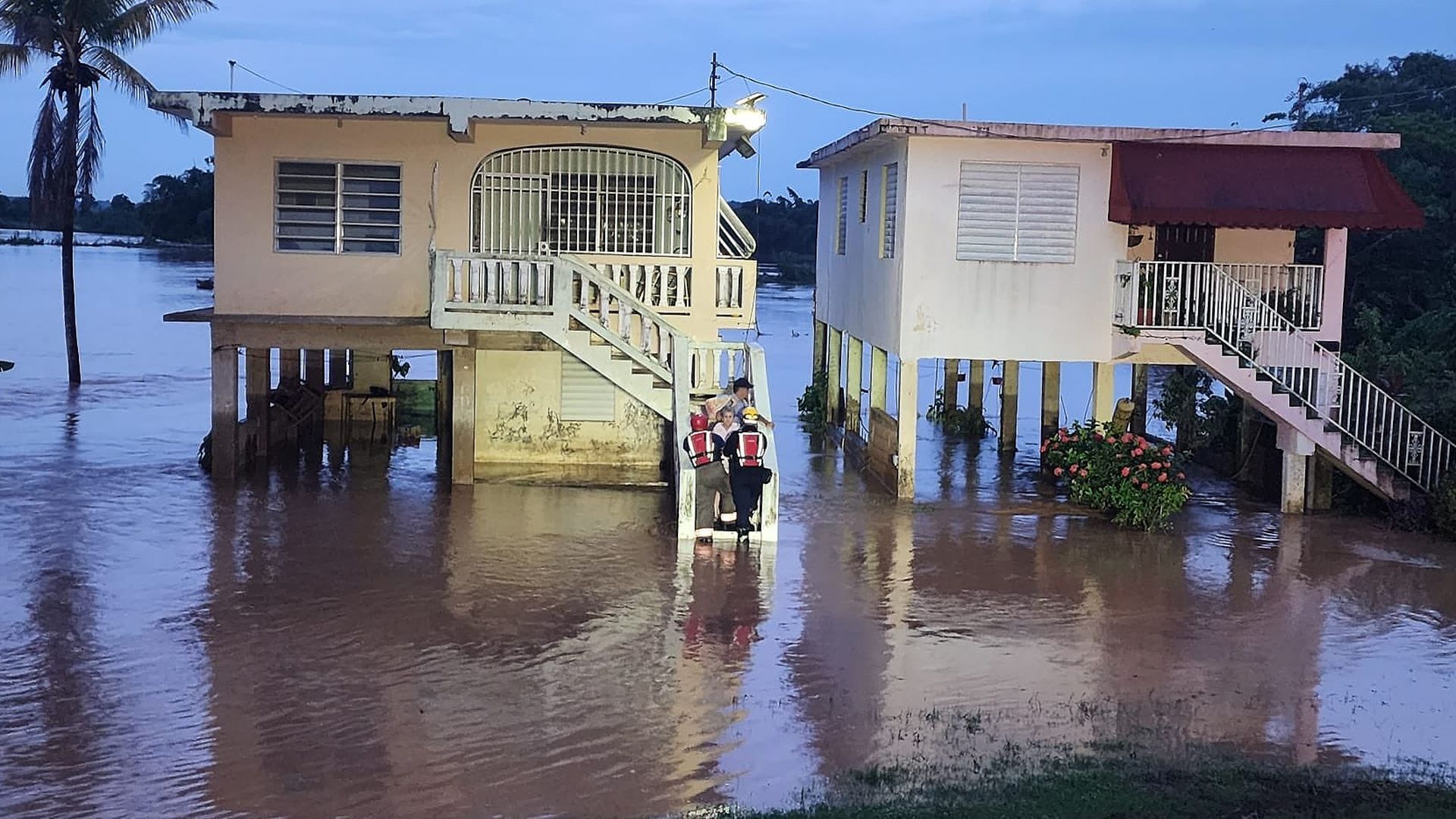 Firefighters from the DOE Barceloneta carried rescue a 91-year-old woman who was trapped in her home after a flood.