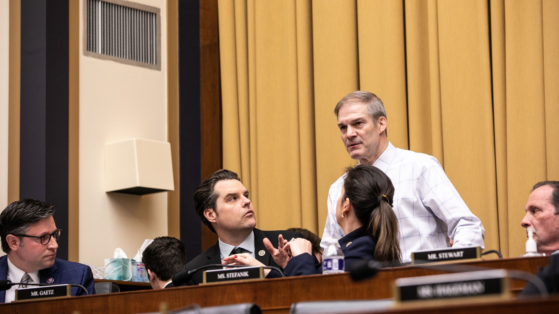 House Judiciary Committee Chair Jim Jordan, wearing a white shirt, speaking to members of the panel behind the dais at a committee hearing.