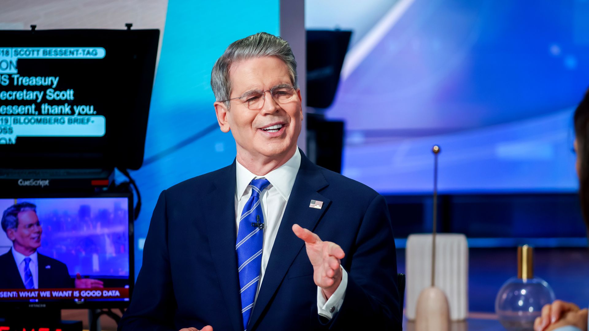 Scott Bessent in a TV studio wearing a blue tie and dark Navy suit