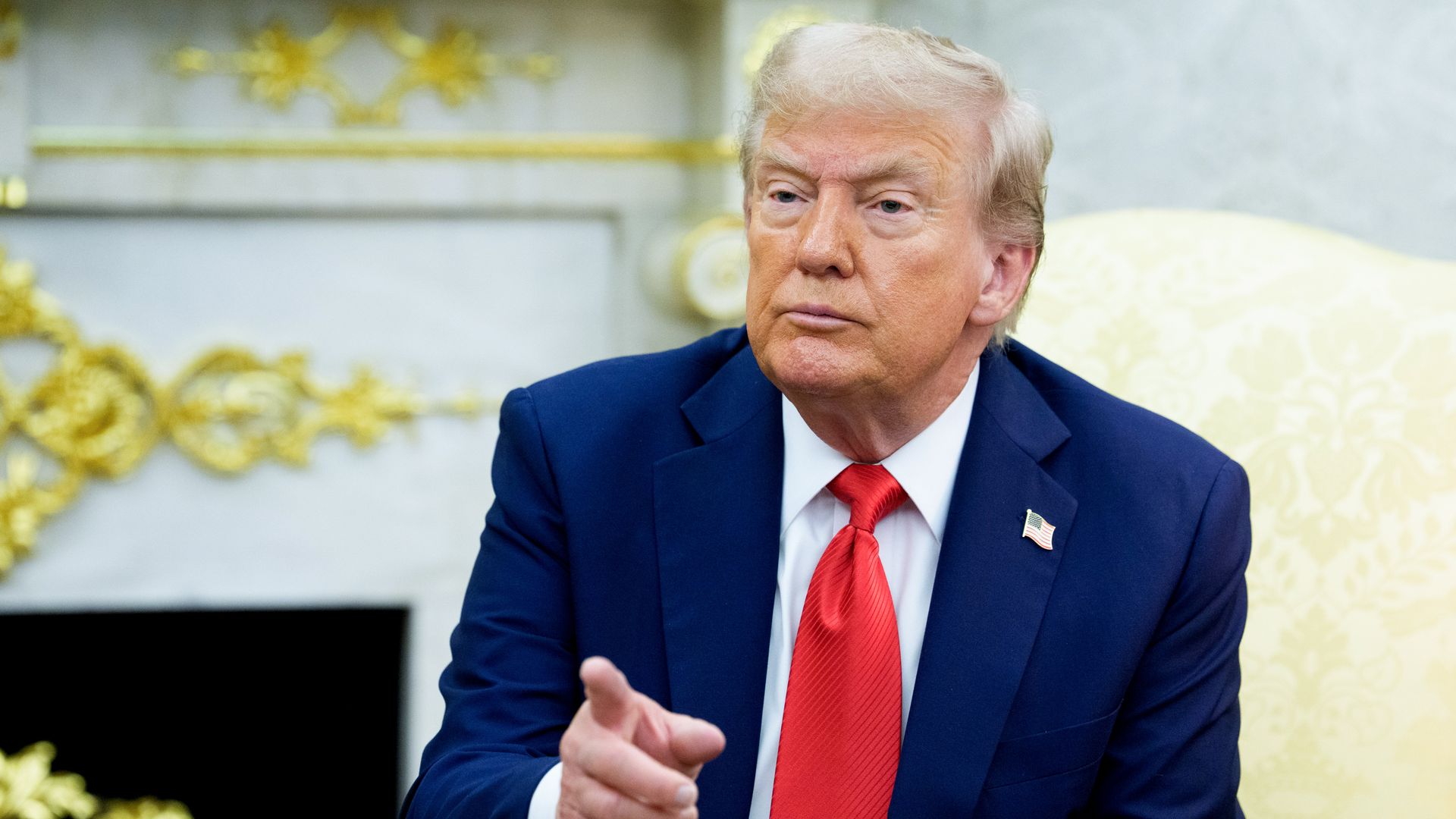 Donald Trump points in the Oval Office