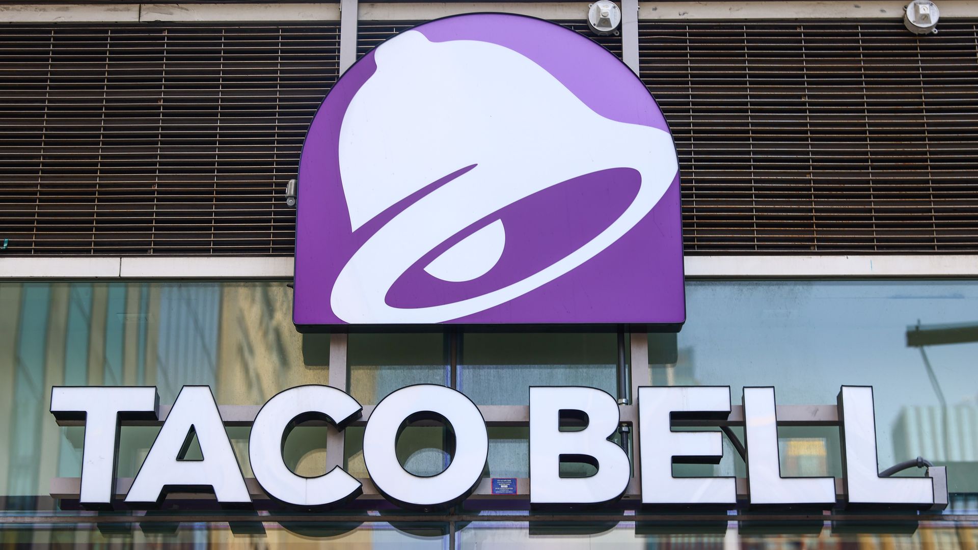 A purple and white sign for Taco Bell