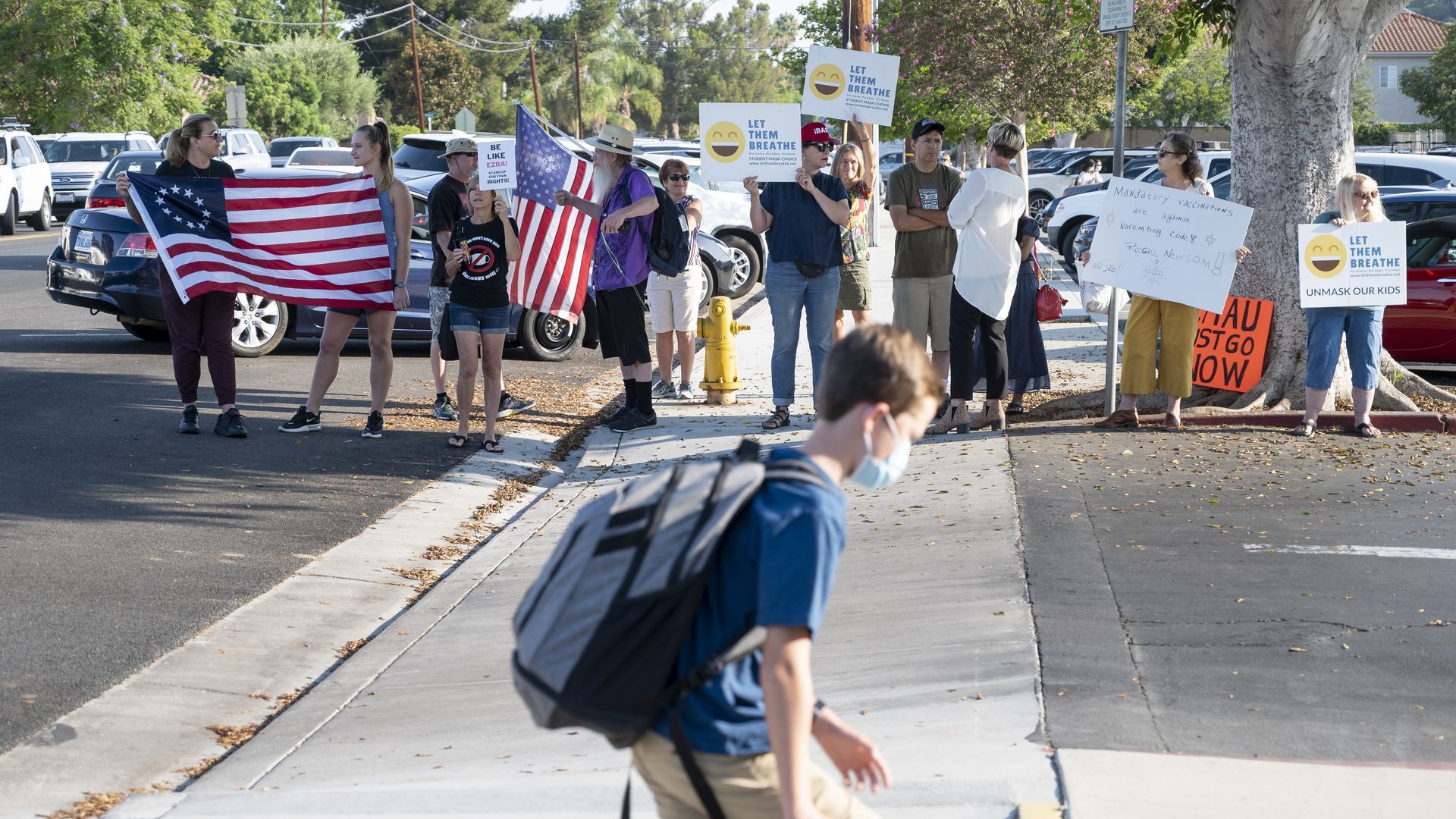 Some 30 protesters rallied outside of Hewes Middle School in Tustin, CA on Friday, Aug. 13. Photo: MediaNews Group/Orange County Register via Getty Images