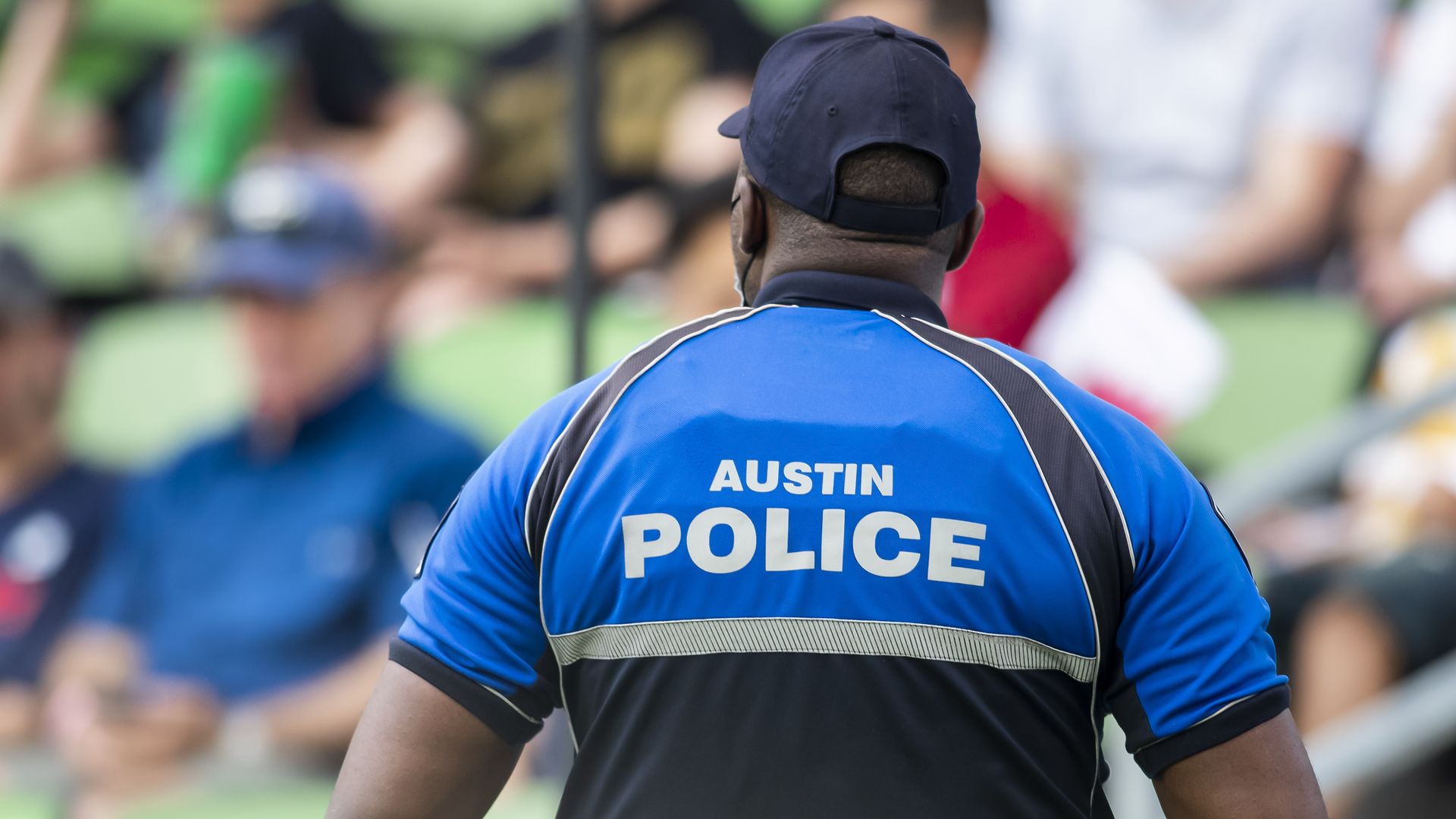 An Austin police officer stands guard at a soccer match in July.