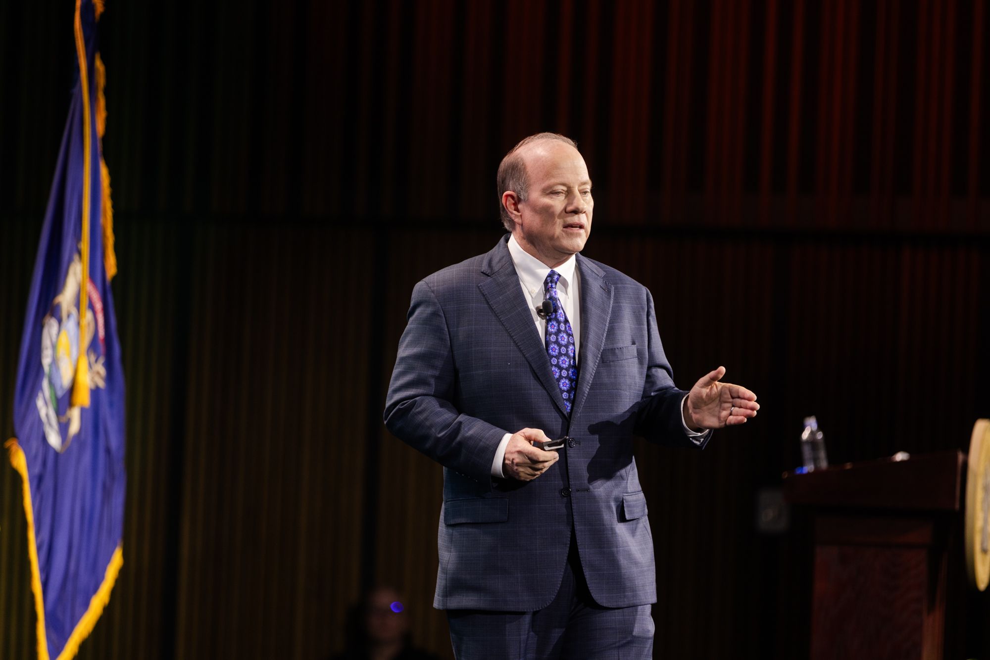 Mike Duggan speaks into a microphone from a stage