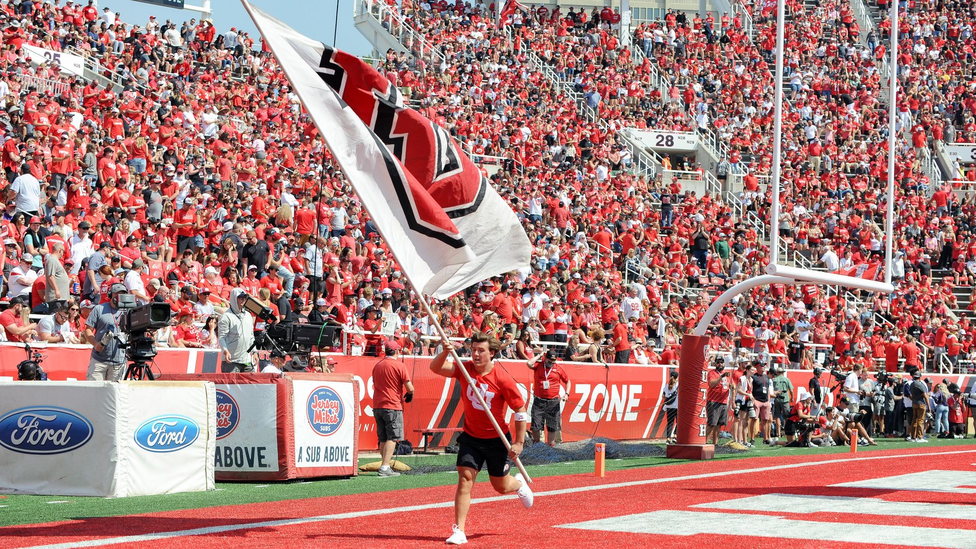 SALT LAKE CITY, UT - SEPTEMBER 10: A Utah cheerleader run with a Utah Flag after a touchdown during a game between Southern Utah Thunderbirds and the University of Utah Utes on September 10, 2022, at Rice-Eccles Stadium in Salt Lake City, Utah. (Photo by Boyd Ivey/Icon Sportswire via Getty Images)