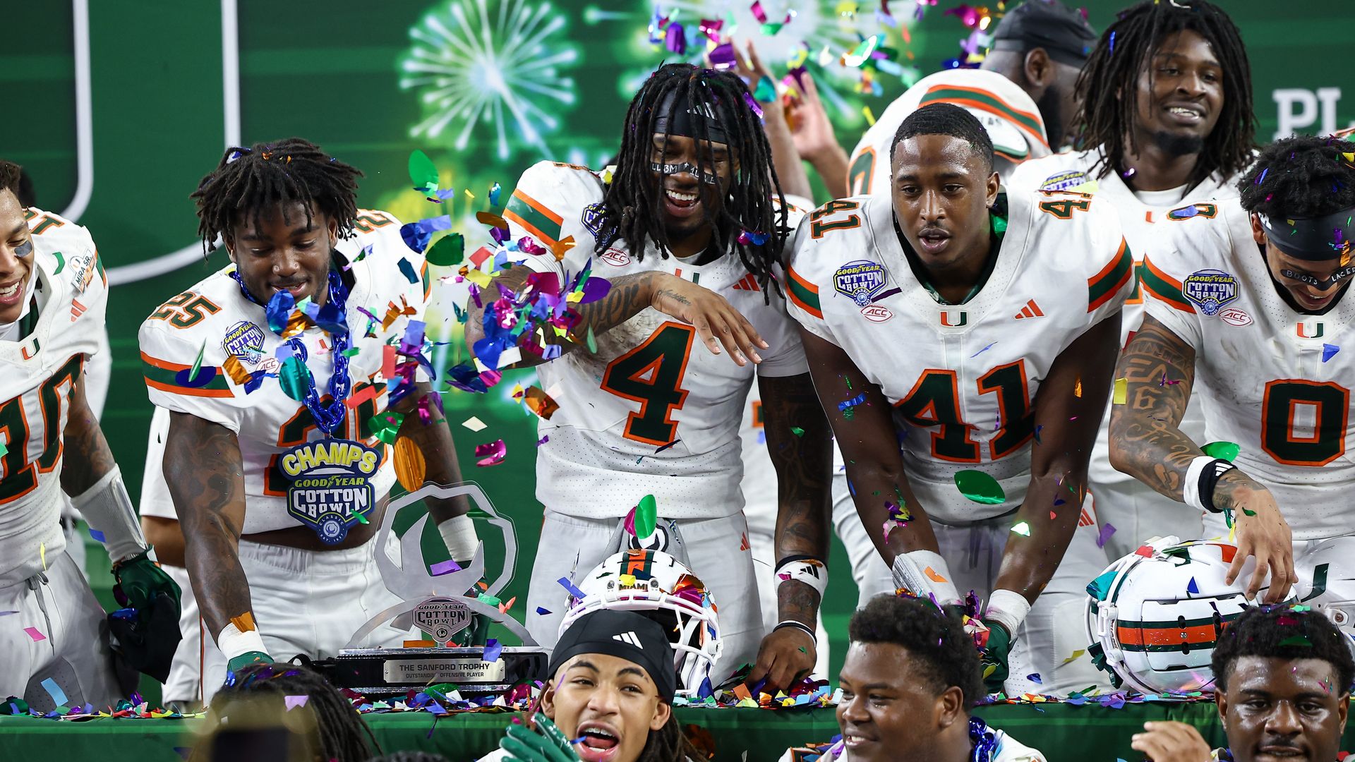 ARLINGTON, TX - DECEMBER 31: Miami Hurricanes running back Mark Fletcher Jr. (#4), defensive back Jadais Richard (#25), and linebacker Chase Smith (#41) throw confetti on teammates during the CFP Quarterfinal Cotton Bowl Classic football game between the Ohio State Buckeyes and Miami Hurricanes on D