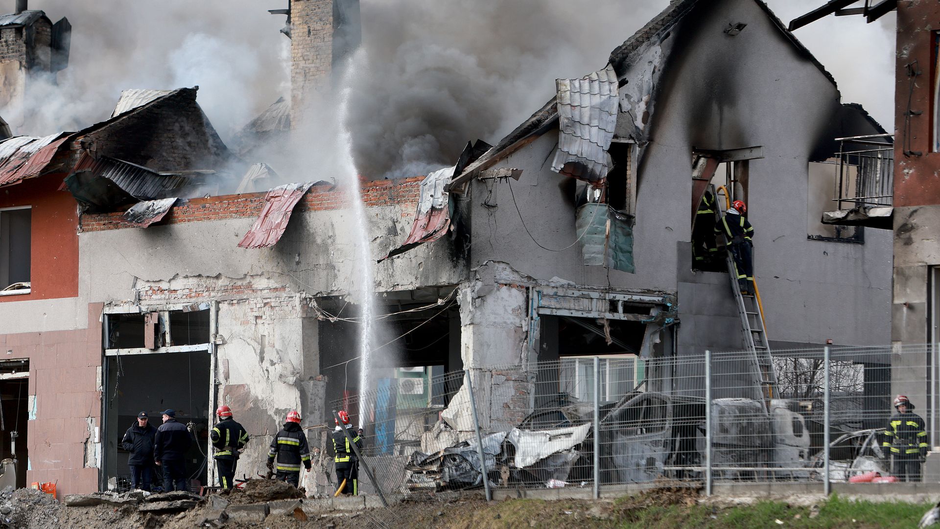 Firefighters battle a blaze after a civilian building was hit by a Russian missile on April 18, 2022 in Lviv, Ukraine.
