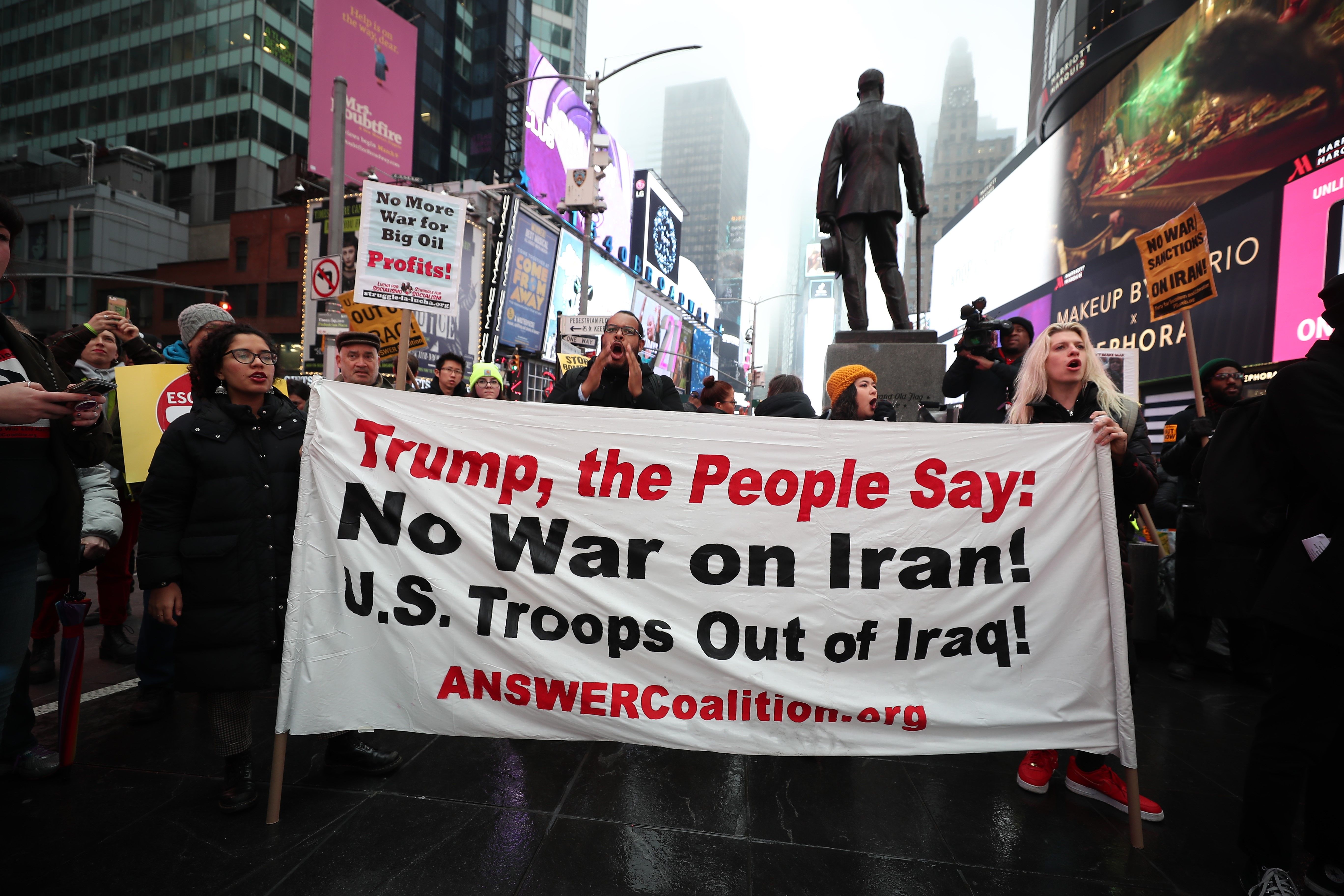 Anti-war activists hold banners during a protestin New York