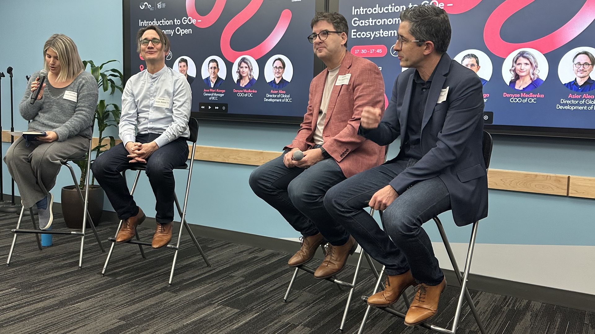 Four people speak at the CIC about gastronomy. CIC founder Tim Rowe and Joxe Mari Zisega, Basque Culinary Center general manager, discuss the new partnership. 