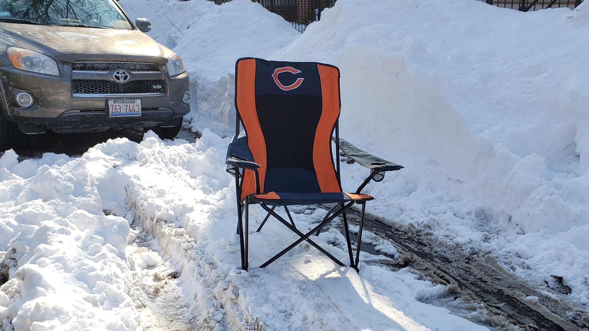 Photo of a chair in the snow. 