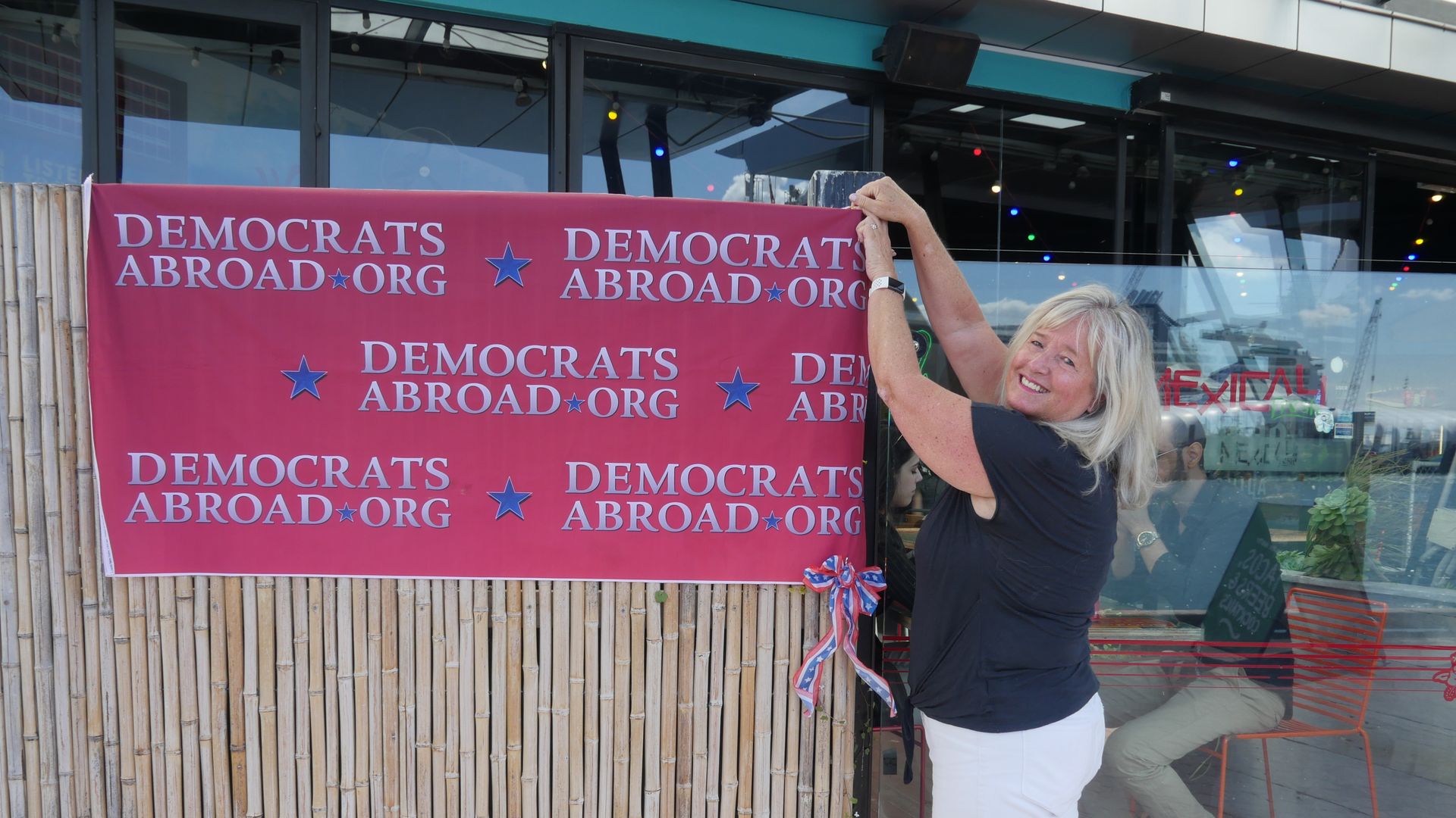 Mexicali Fresh owner Cindy Buell puts the finishing touches to a sign at her restaurant, which became a polling station for the day in Auckland, New Zealand