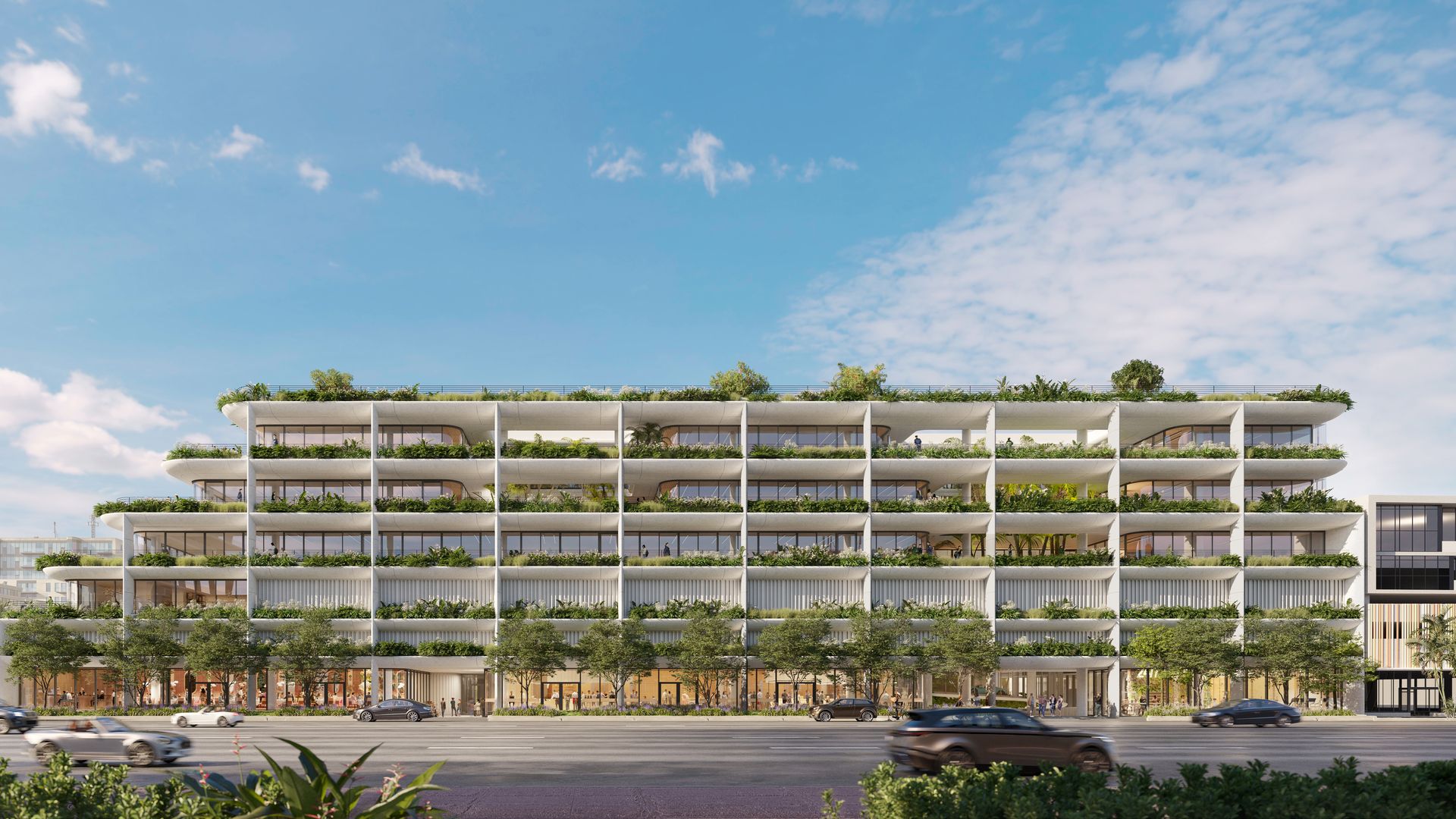 A six story, wide white building with plants on balconies 