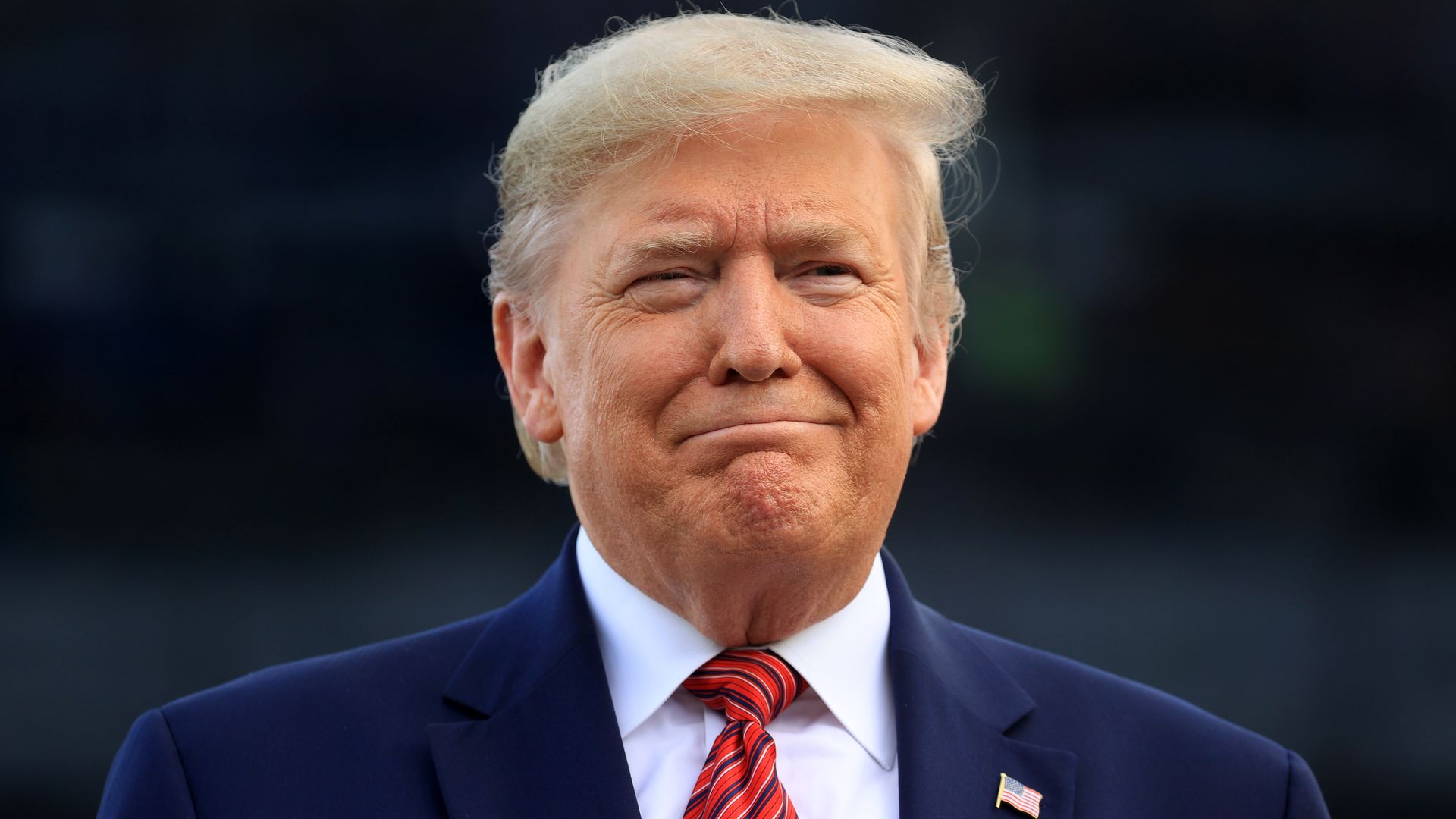 Donald Trump is pictured in a close-up smile