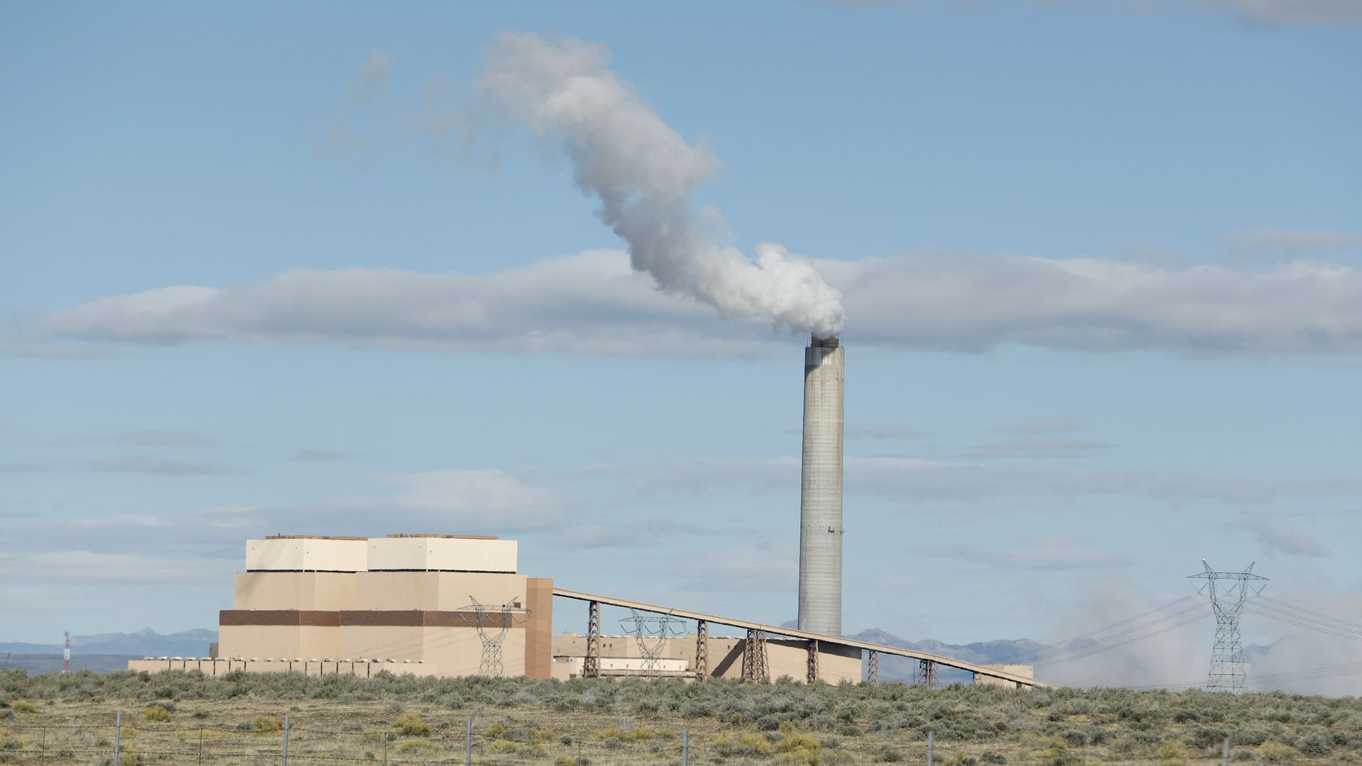 a coal-fired power plant giving off smoke