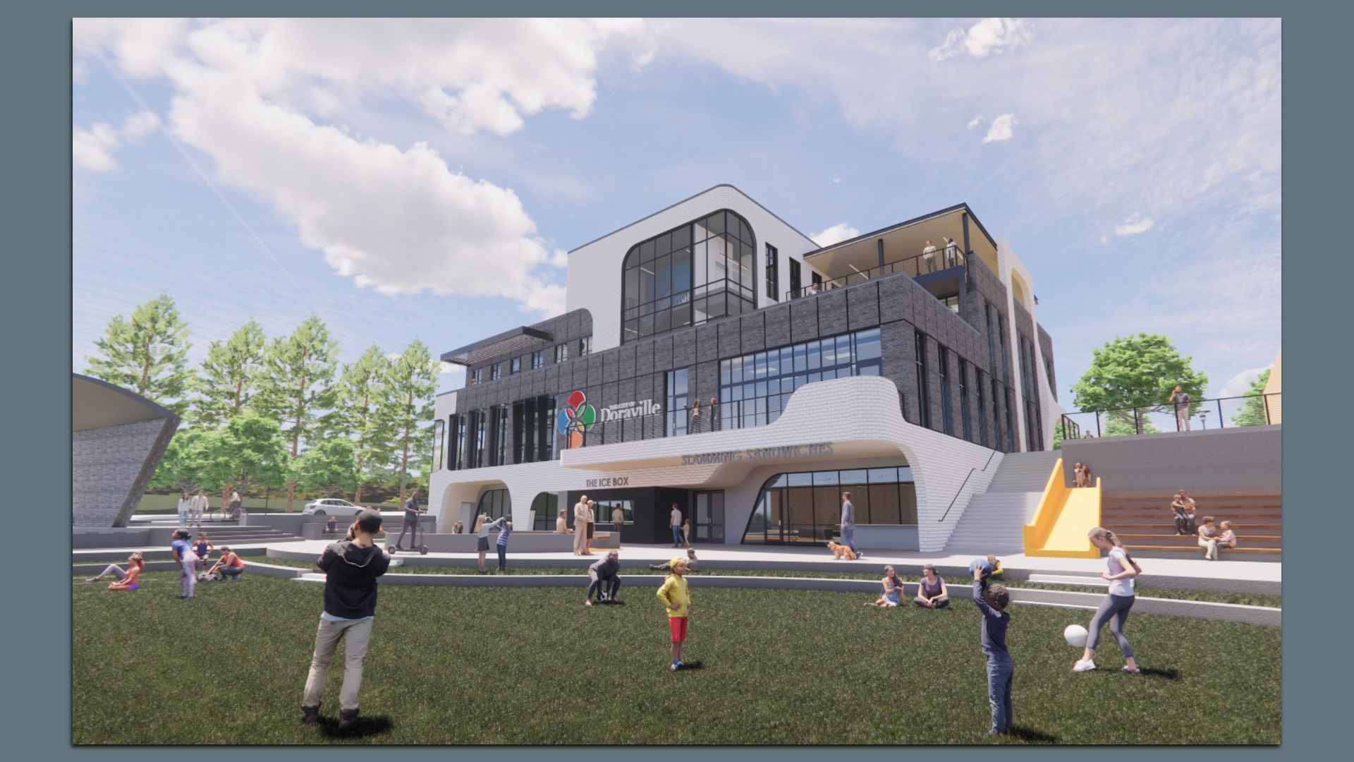 Modern multi-story community center with large windows, sign "Doraville," outdoor seating, trees, a grassy area with people and children playing, and a yellow slide by stairs.
