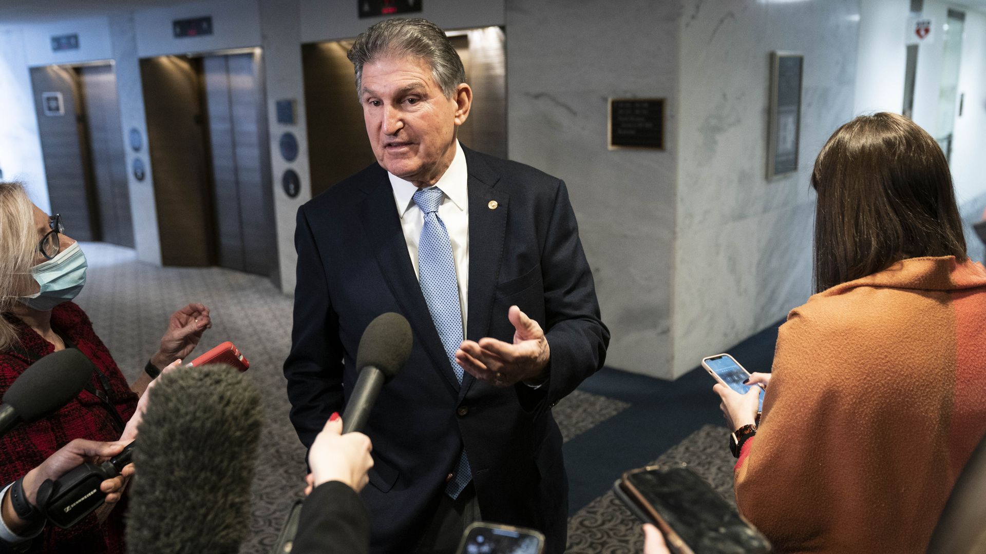 Sen. Joe Manchin is seen speaking with reporters.