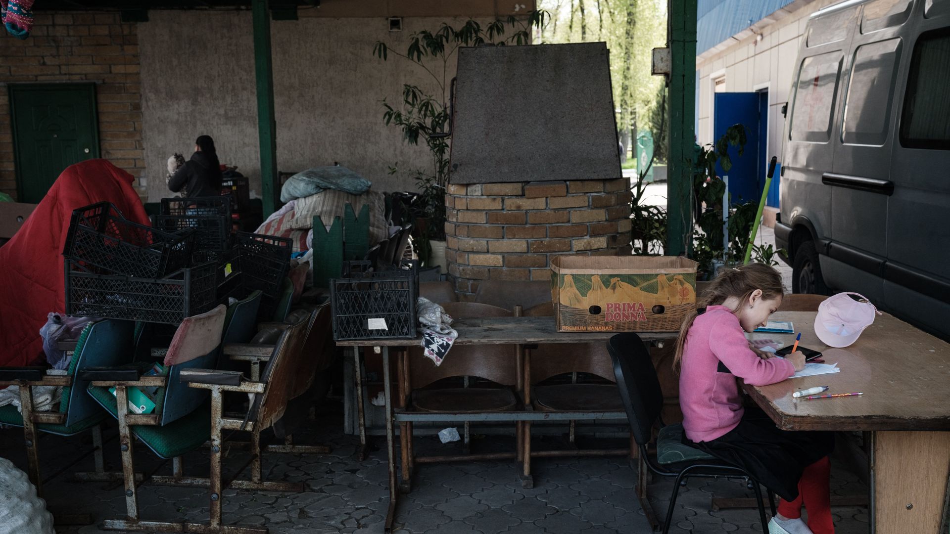 A girl studies with a smartphone as she attends online schooling near the frontline, in Pokrovske, eastern Ukraine, on May 4, 2022, amid the Russian invasion of Ukraine