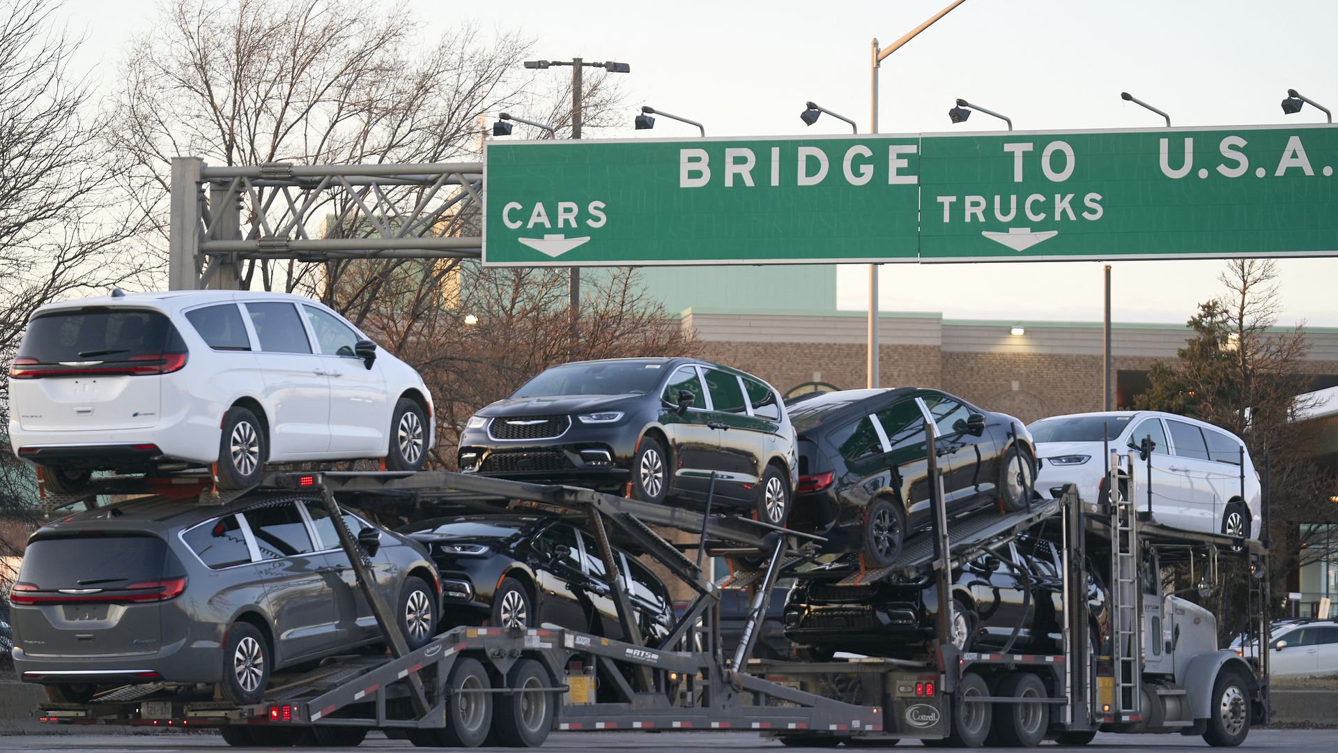 A car carrier loaded with vehicles crosses from Canada into the U.S.