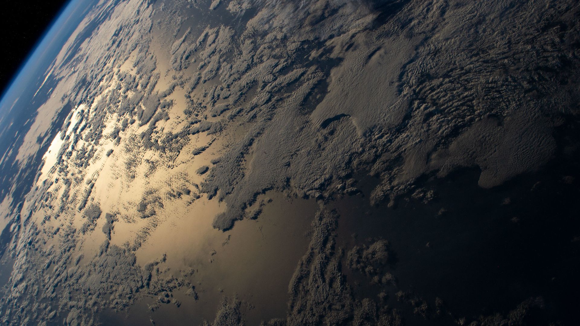The sun glinting off of the ocean as seen from space