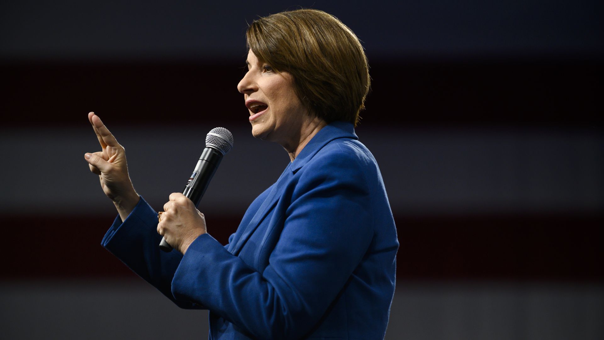 A photo of Sen. Amy Klobuchar speaking into a microphone and pointing a finger.