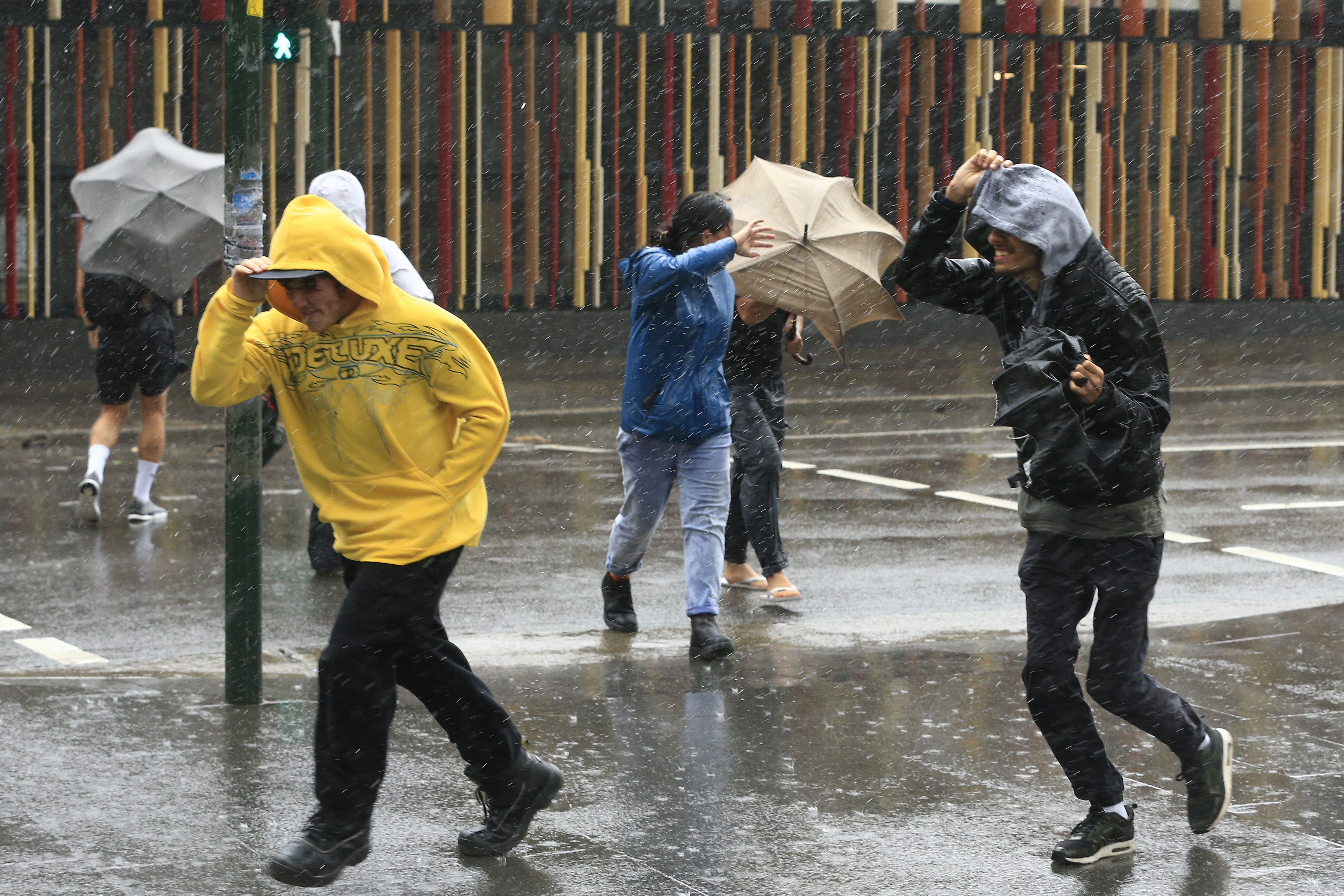 People struggle with the wind and rain on February 09, 2020 in Sydney
