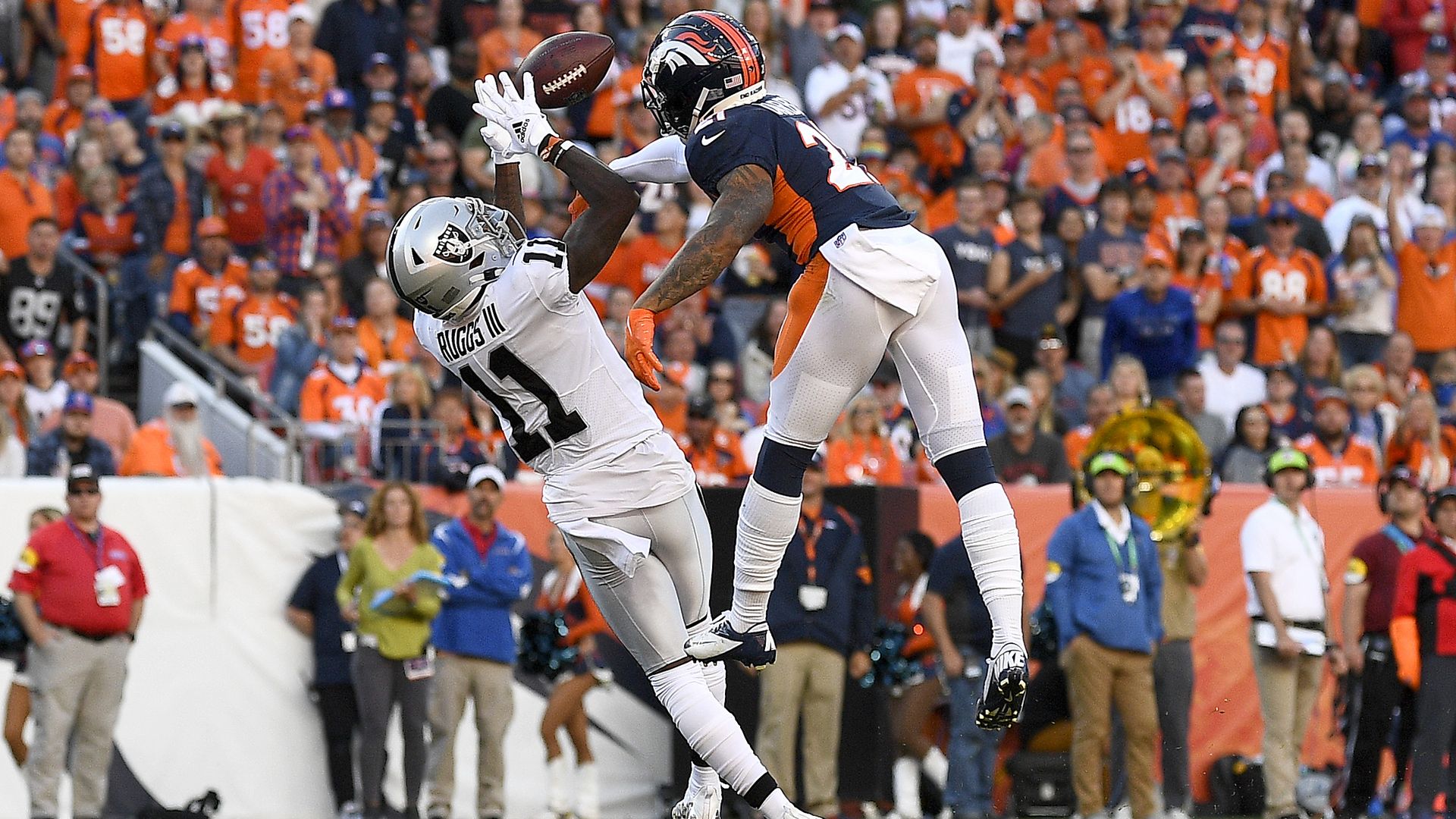Henry Ruggs III #11 of the Las Vegas Raiders completes a catch against Ronald Darby #21 of the Denver Broncos during the third quarter at Empower Field At Mile High on Oct. 17.