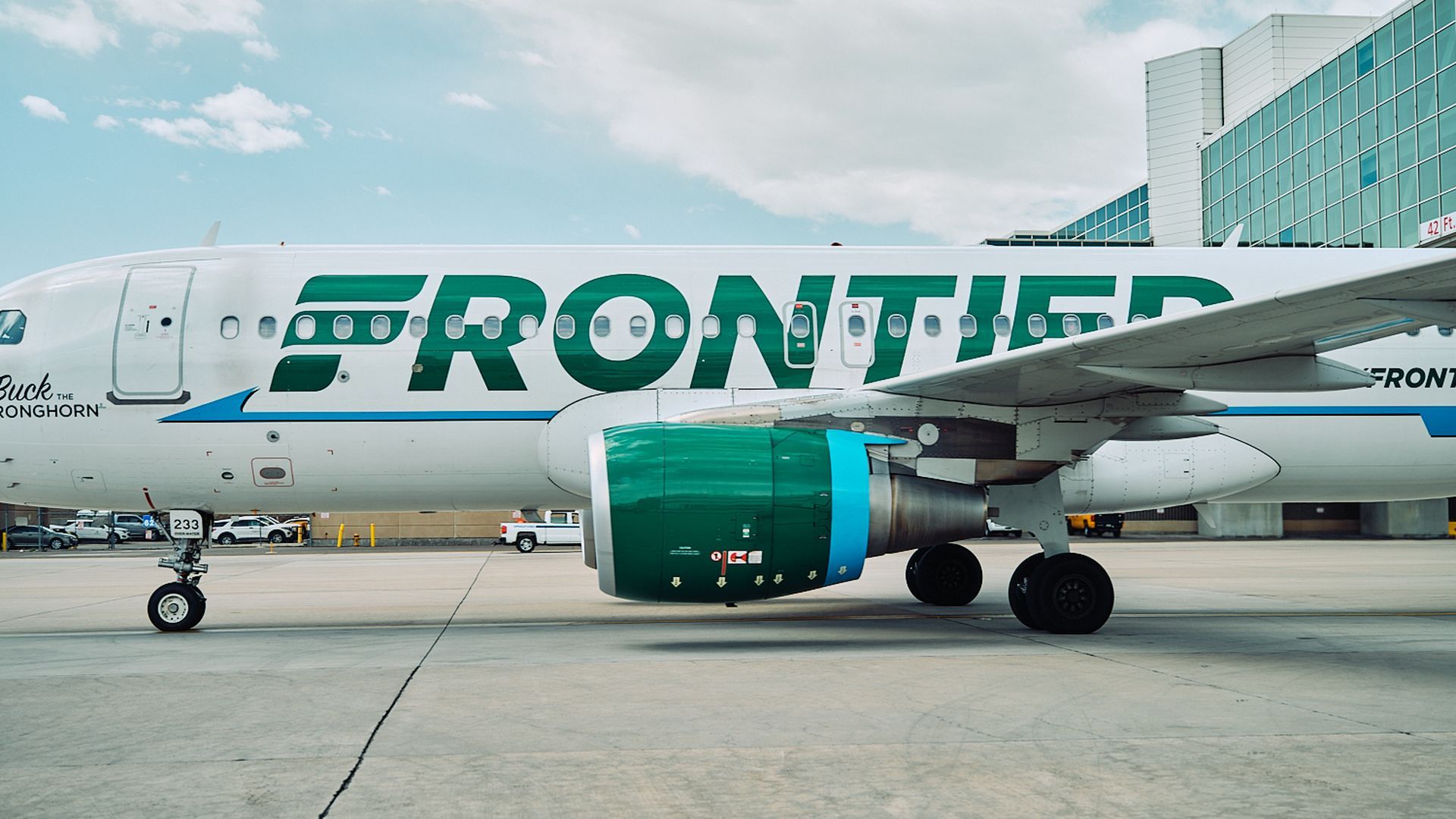 Frontier Airlines jet in profile on tarmac