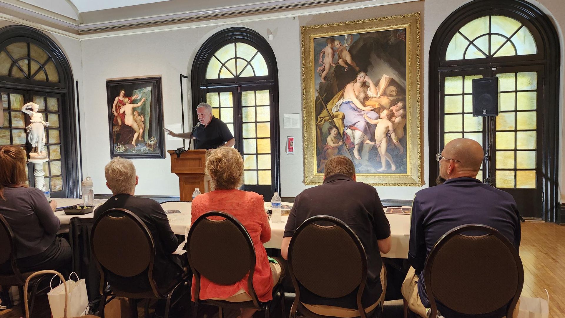 A photo of paintings on display at Hoyt Sherman Place in Des Moines.