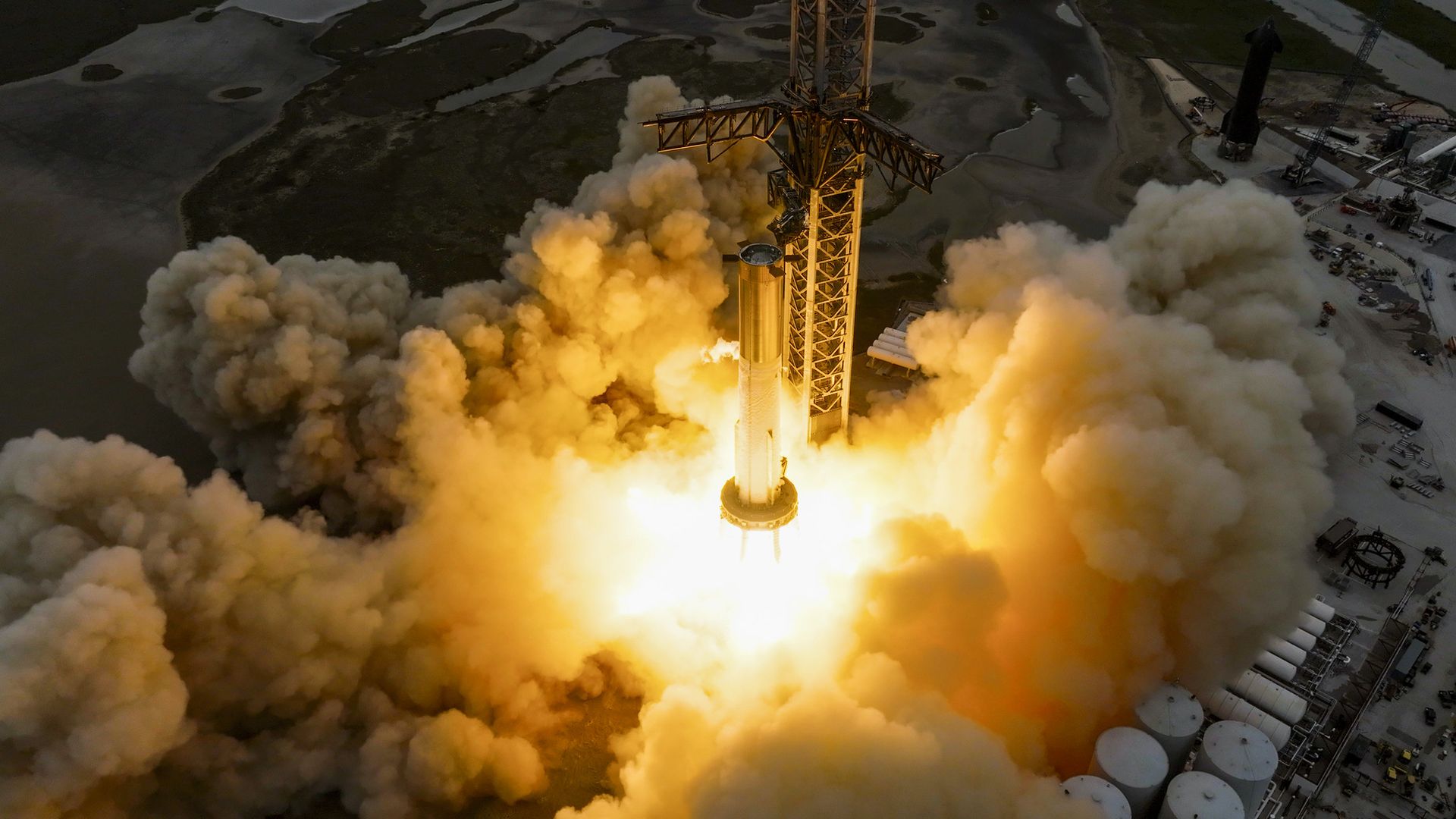Fire and smoke billow from a Super Heavy rocket test firing