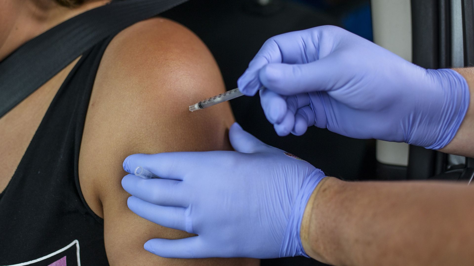 A health worker administering a coronavirus vaccine in Austin, Texas, on Aug. 5.