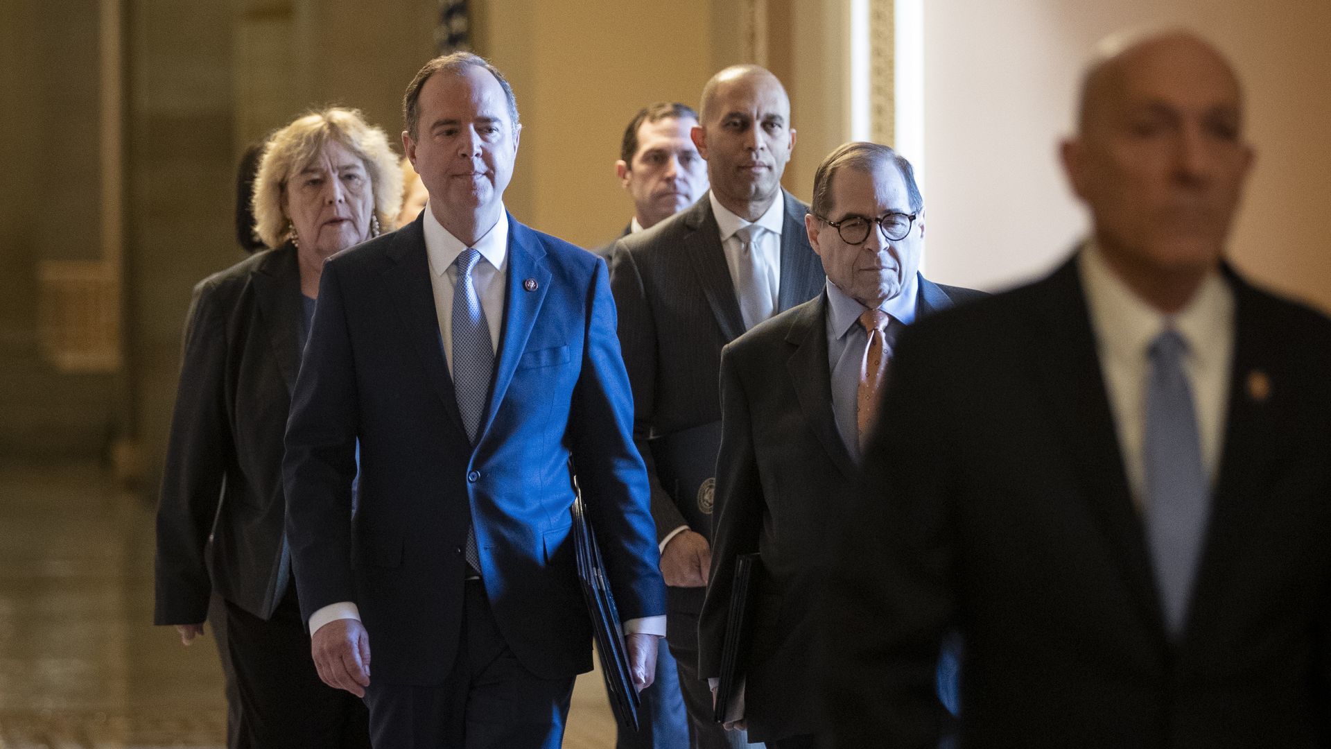 Led by House Sergeant at Arms Paul D. Irving, House impeachment managers walk to the Senate chamber for the impeachment proceedings
