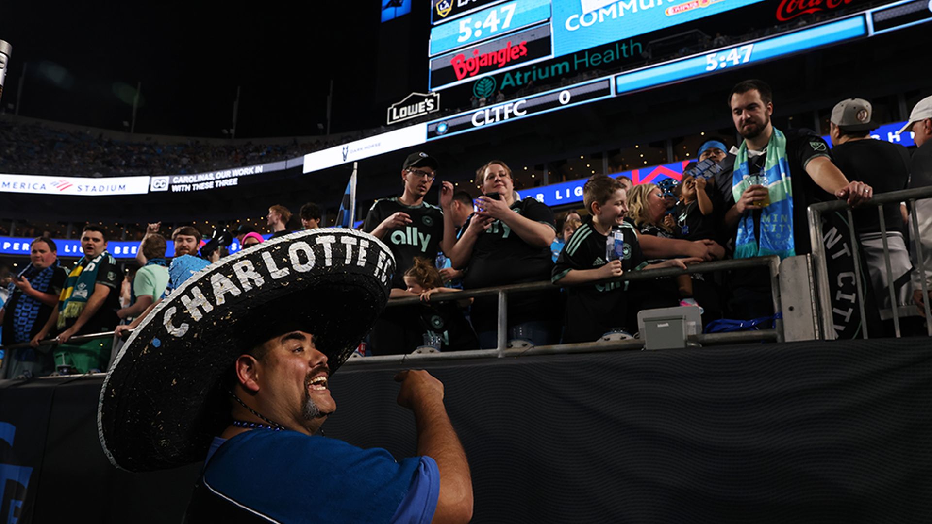 Hector Cortes organizes supporters at Charlotte FC’s inaugural home match at Bank of America Stadium on March 5, 2022. Photo: Travis Dove/Axios
