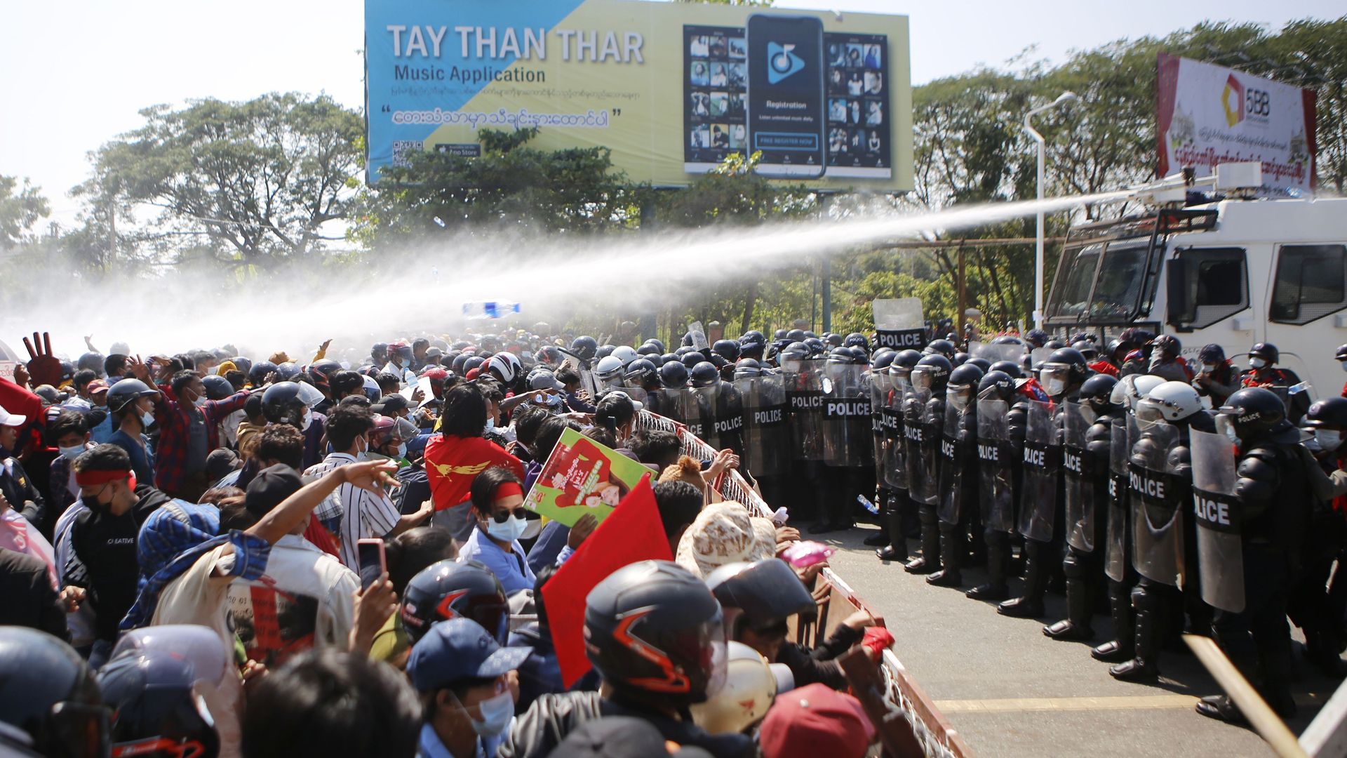 Photo of police using water cannons against a crowd of protesters in Myanmar