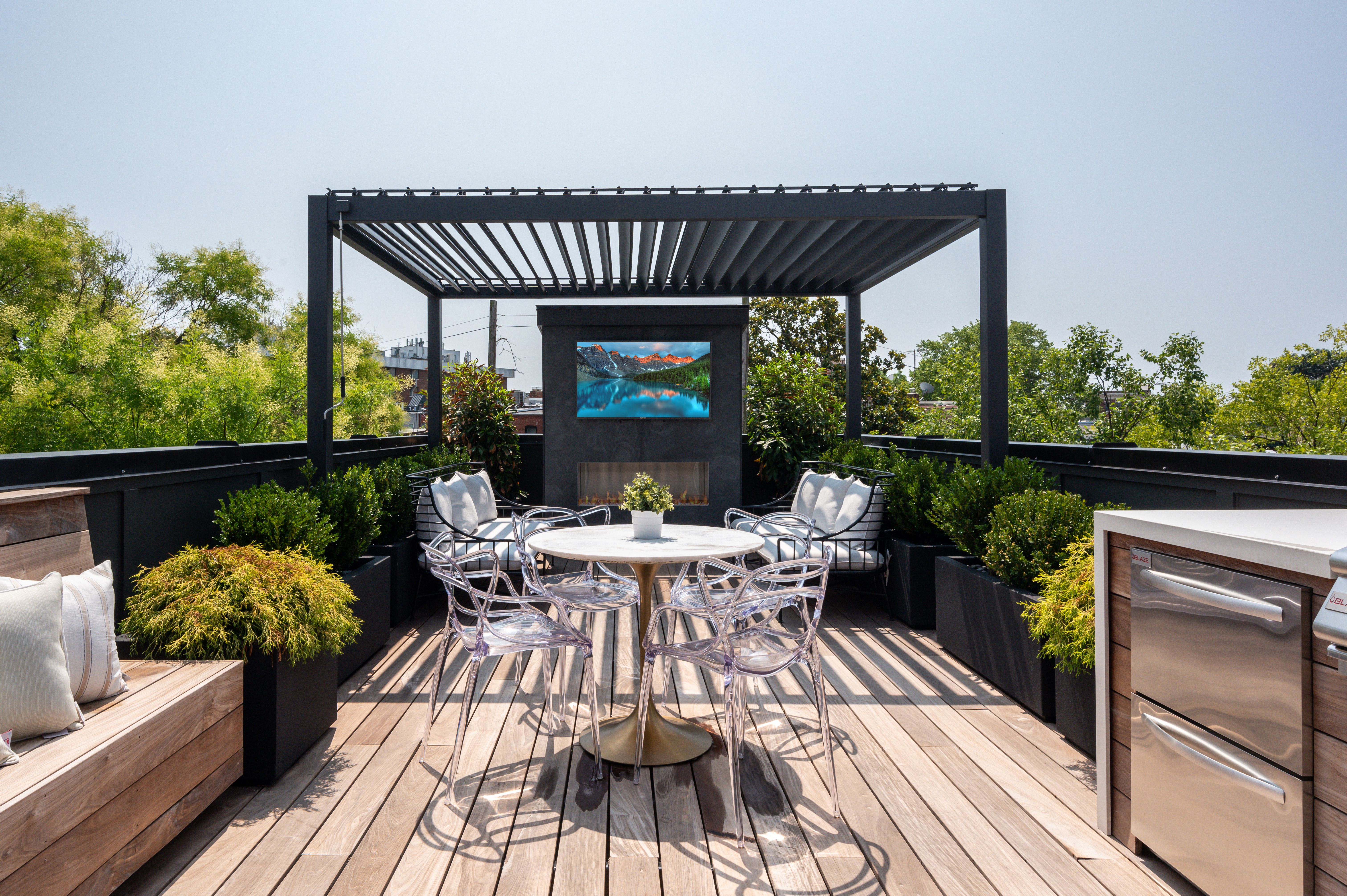 rooftop deck with pergola, dining table and TV